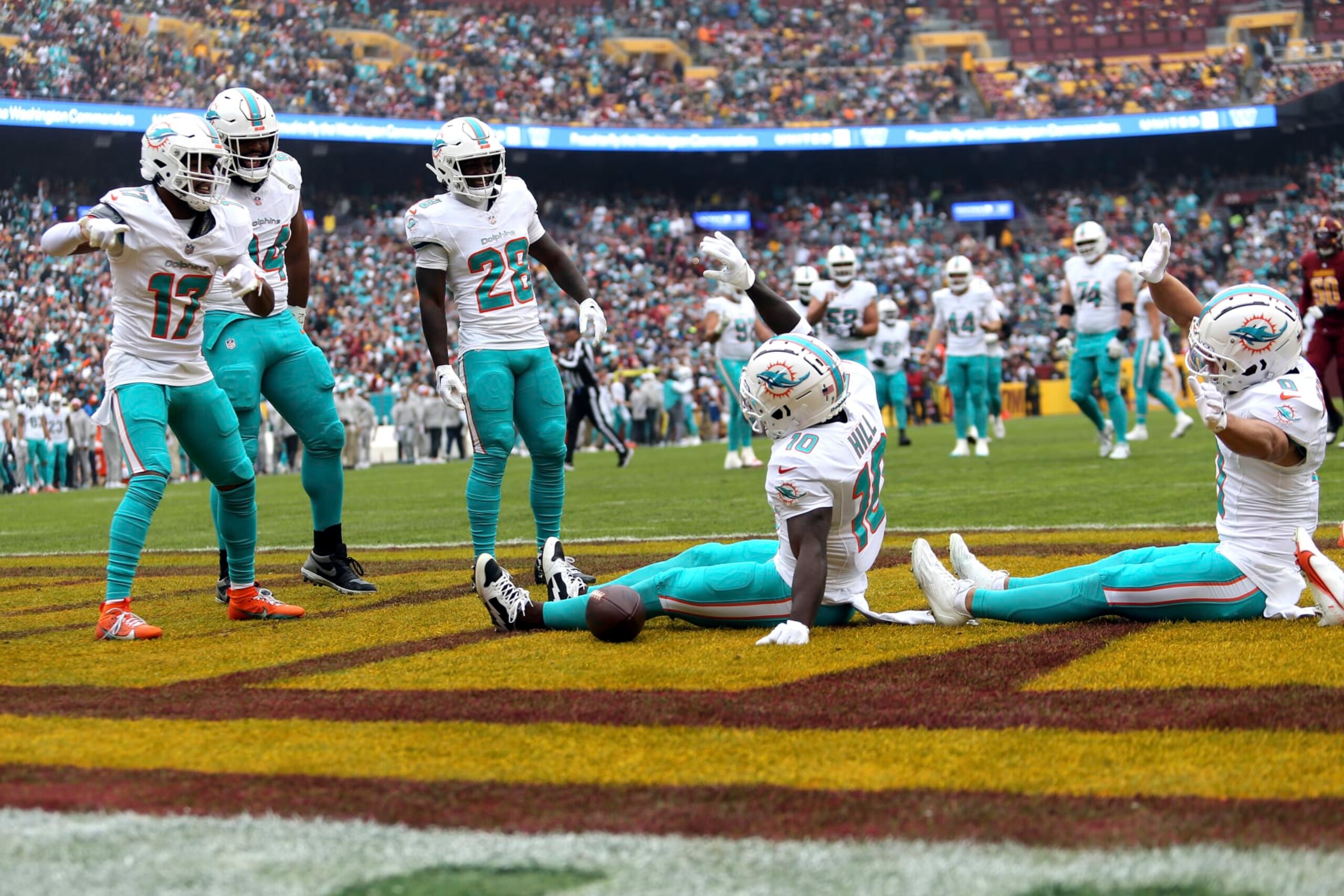 Miami Dolphins wide receiver Tyreek Hill (10) celebrates with his teammates after scoring a touchdown during an NFL football game against the Washington Commanders, Sunday, December 03, 2023 in Landover, Md. (AP Photo/Daniel Kucin Jr.)