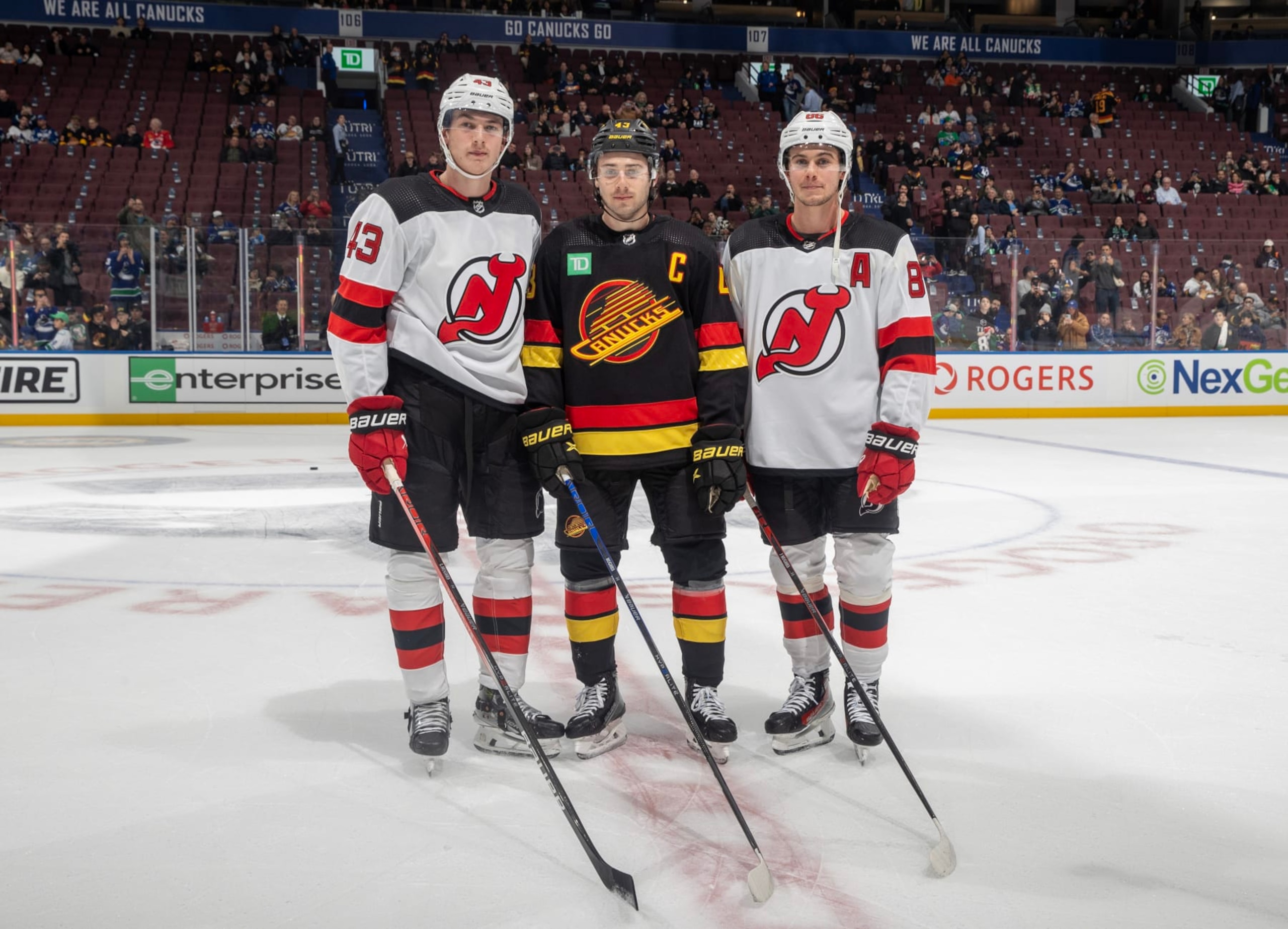 VANCOUVER, CANADA - DECEMBER 05: Quinn Hughes #43 of the Vancouver Canucks and Jack Hughes #86 and Luke Hughes #43 of the New Jersey Devils pose for a photo before their NHL game at Rogers Arena on December 5, 2023 in Vancouver, British Columbia, Canada.  (Photo by Jeff Vinnick/NHLI via Getty Images)