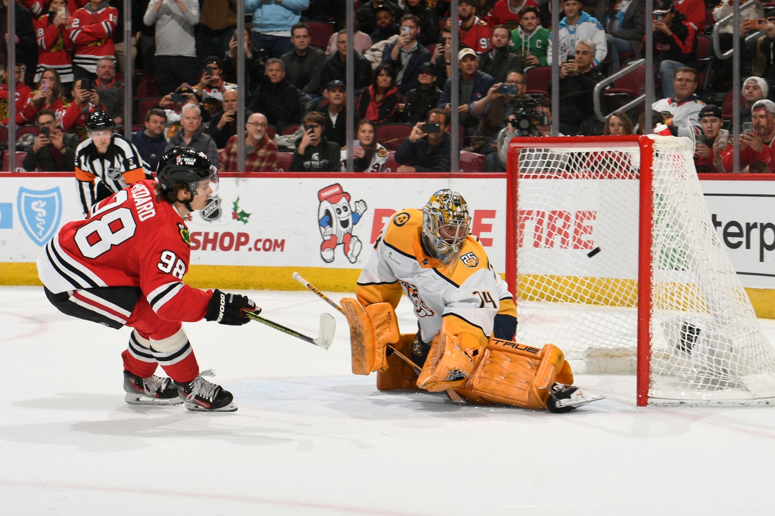 CHICAGO, ILLINOIS - DECEMBER 05: Connor Bedard #98 of the Chicago Blackhawks scores in the shoot-out against goalie Juuse Saros #74 of the Nashville Predators at the United Center on December 05, 2023 in Chicago, Illinois. (Photo by Bill Smith/NHLI via Getty Images)