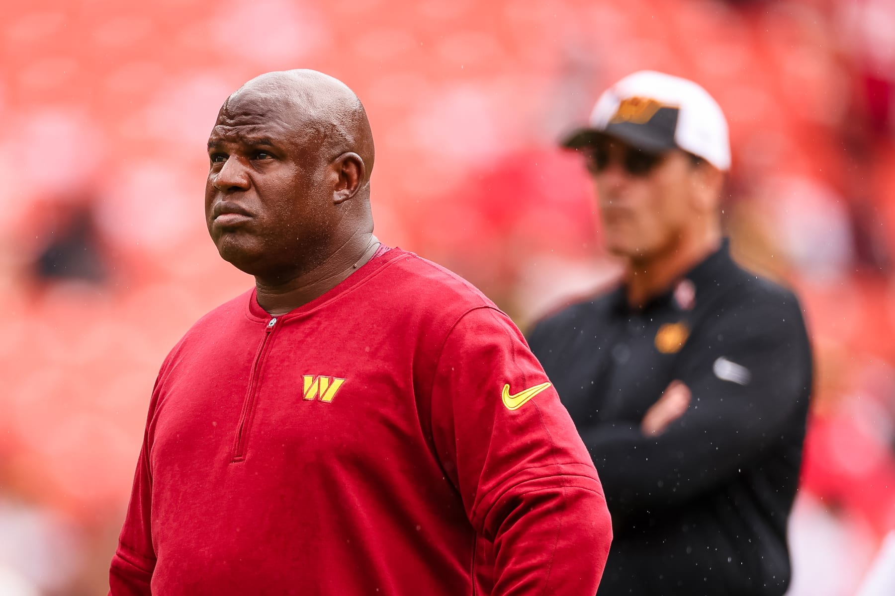 LANDOVER, MD - SEPTEMBER 10: Assistant head coach and offensive coordinator Eric Bieniemy looks on as head coach Ron Rivera watches his team before the game against the Arizona Cardinals at FedExField on September 10, 2023 in Landover, Maryland. (Photo by Scott Taetsch/Getty Images)