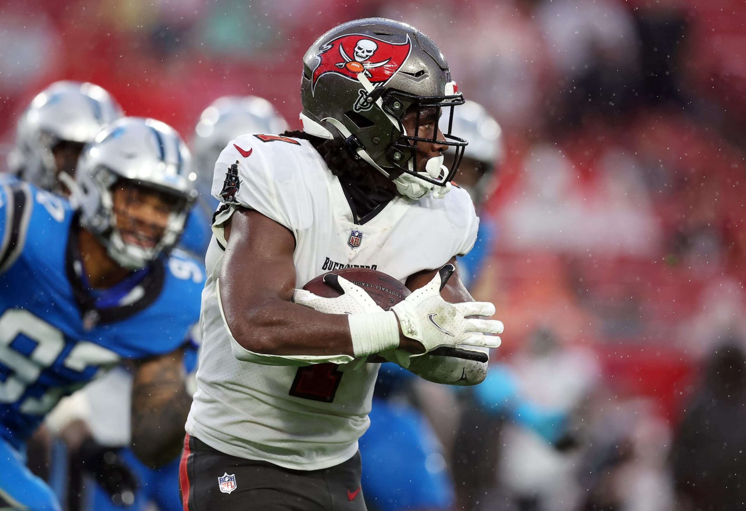TAMPA, FLORIDA - DECEMBER 03: Rachaad White #1 of the Tampa Bay Buccaneers carries the ball against the Carolina Panthers during the first half at Raymond James Stadium on December 03, 2023 in Tampa, Florida. (Photo by Mike Carlson/Getty Images)