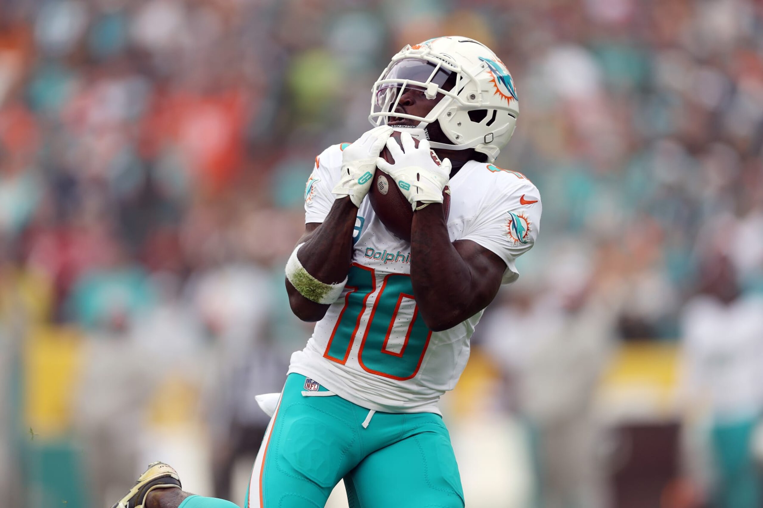 LANDOVER, MARYLAND - DECEMBER 03: Tyreek Hill #10 of the Miami Dolphins catches a pass for a touchdown against the Washington Commanders during the second quarter of the game at FedExField on December 03, 2023 in Landover, Maryland. (Photo by Patrick Smith/Getty Images)