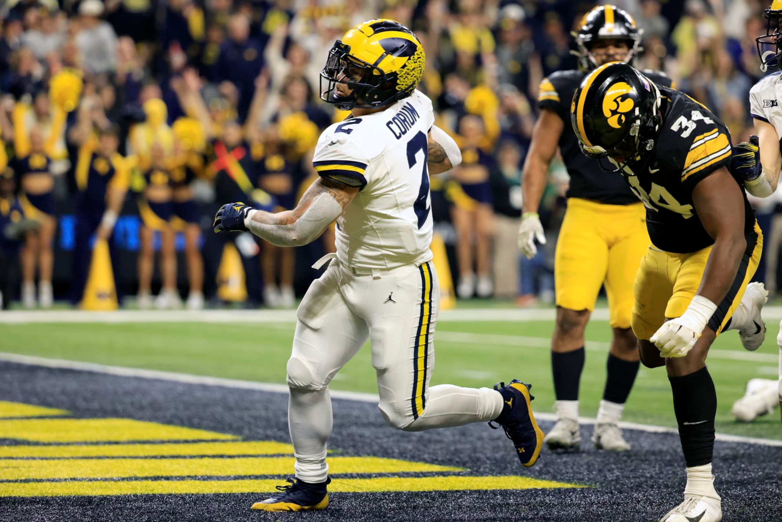 INDIANAPOLIS, INDIANA - DECEMBER 02: Blake Corum #2 of the Michigan Wolverines runs the ball for a touchdown in the game against the Iowa Hawkeyes during the first quarter during the Big Ten Championship at Lucas Oil Stadium on December 02, 2023 in Indianapolis, Indiana. (Photo by Justin Casterline/Getty Images) INDIANAPOLIS, INDIANA - DECEMBER 02: Blake Corum #2 of the Michigan Wolverines runs the ball for a touchdown in the game against the Iowa Hawkeyes during the first quarter during the Big Ten Championship at Lucas Oil Stadium on December 02, 2023 in Indianapolis, Indiana. (Photo by Justin Casterline/Getty Images)