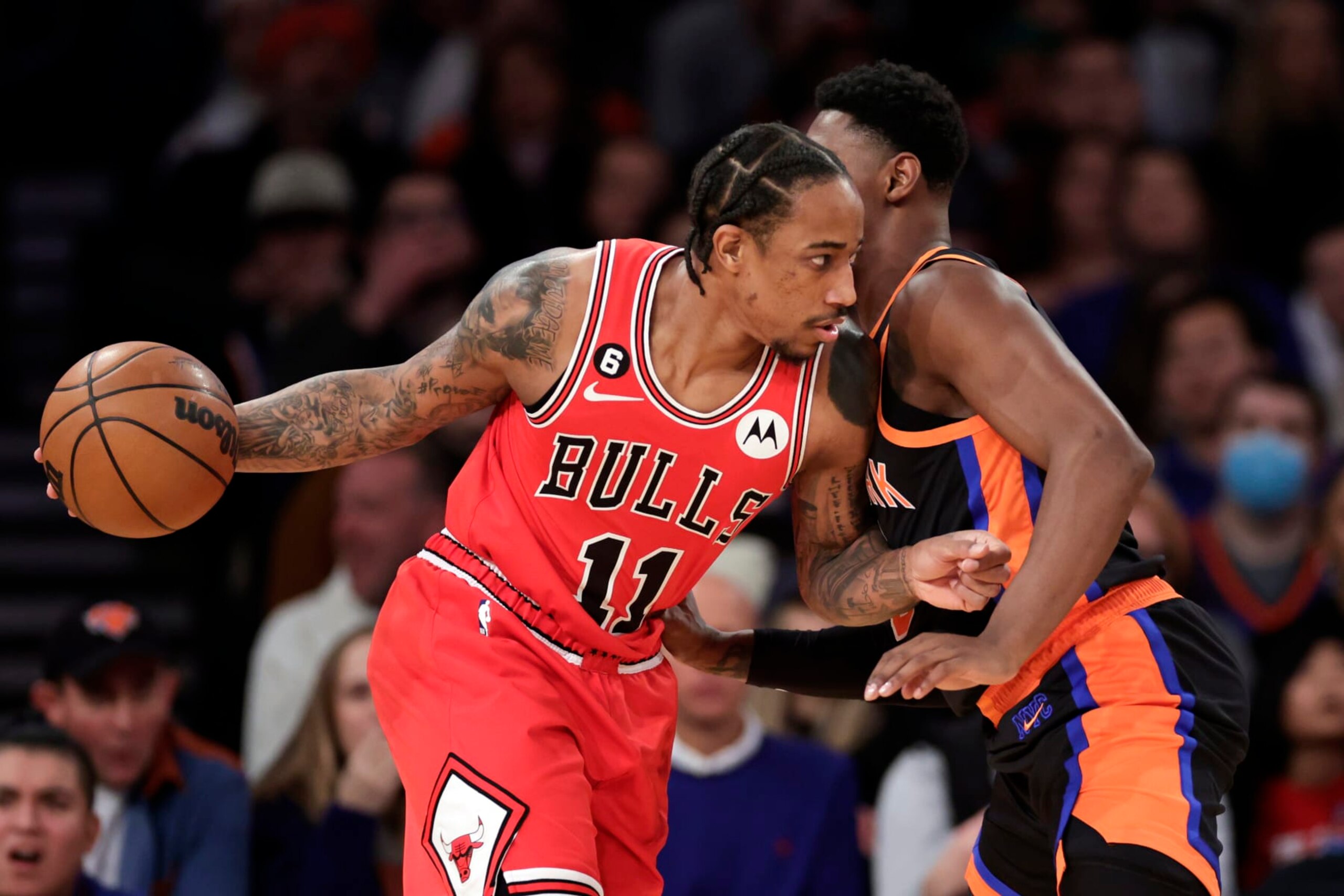 NEW YORK, NEW YORK - DECEMBER 23: DeMar DeRozan #11 of the Chicago Bulls drives to the basket against RJ Barrett #9 of the New York Knicks during the first half at Madison Square Garden on December 23, 2022 in New York City. NOTE TO USER: User expressly acknowledges and agrees that, by downloading and or using this Photograph, user is consenting to the terms and conditions of the Getty Images License Agreement.  (Photo by Adam Hunger/Getty Images)
