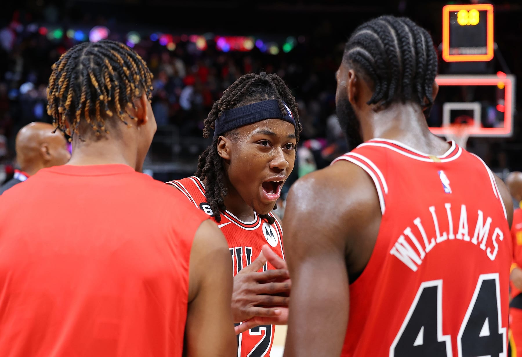 ATLANTA, GEORGIA - DECEMBER 21:  Ayo Dosunmu #12 of the Chicago Bulls reacts with Dalen Terry #25 and Patrick Williams #44 after hitting the game-winning basket as time expired in their 110-108 win over the Atlanta Hawks at State Farm Arena on December 21, 2022 in Atlanta, Georgia.  NOTE TO USER: User expressly acknowledges and agrees that, by downloading and or using this photograph, User is consenting to the terms and conditions of the Getty Images License Agreement.  (Photo by Kevin C. Cox/Getty Images)