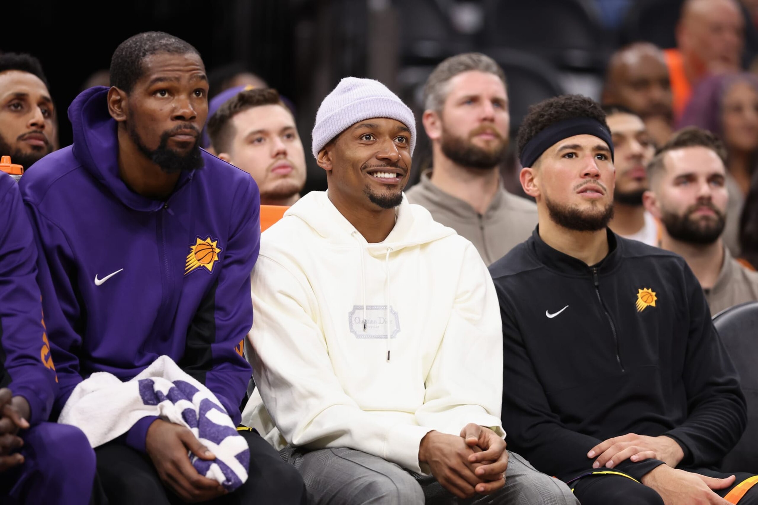 PHOENIX, ARIZONA - NOVEMBER 15: (L-R) Kevin Durant #35, Bradley Beal #3 and Devin Booker #1 of the Phoenix Suns watch from the bench during the second half of the NBA game against the Minnesota Timberwolves at Footprint Center on November 15, 2023 in Phoenix, Arizona. The Suns defeated the Timberwolves 133-115. NOTE TO USER: User expressly acknowledges and agrees that, by downloading and or using this photograph, User is consenting to the terms and conditions of the Getty Images License Agreement.  (Photo by Christian Petersen/Getty Images)