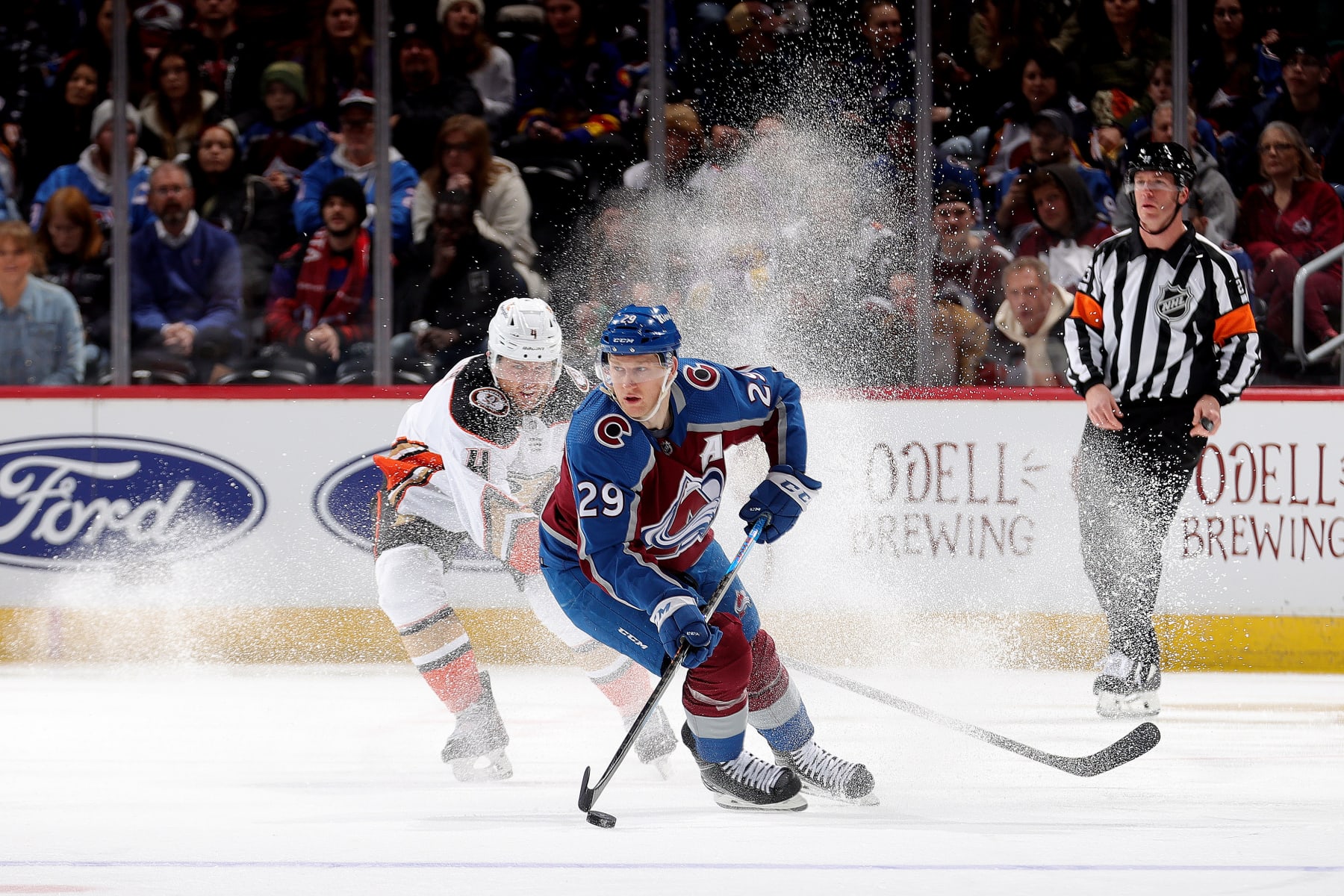 DENVER, COLORADO - DECEMBER 05: Nathan MacKinnon #29 of the Colorado Avalanche skates against Cam Fowler #4 of the Anaheim Ducks at Ball Arena on December 5, 2023 in Denver, Colorado. (Photo by Michael Martin/NHLI via Getty Images)