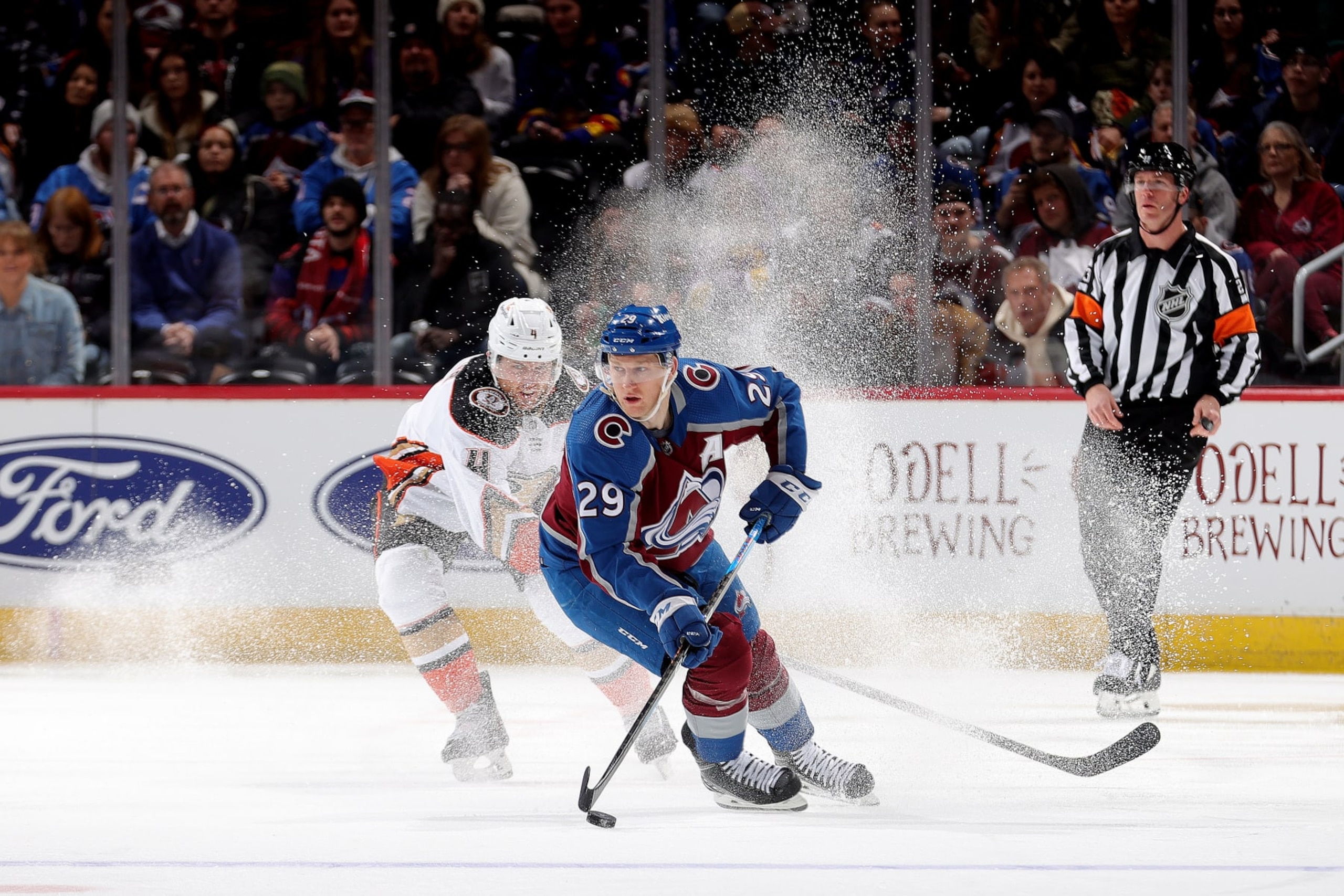 DENVER, COLORADO - DECEMBER 05: Nathan MacKinnon #29 of the Colorado Avalanche skates against Cam Fowler #4 of the Anaheim Ducks at Ball Arena on December 5, 2023 in Denver, Colorado. (Photo by Michael Martin/NHLI via Getty Images)