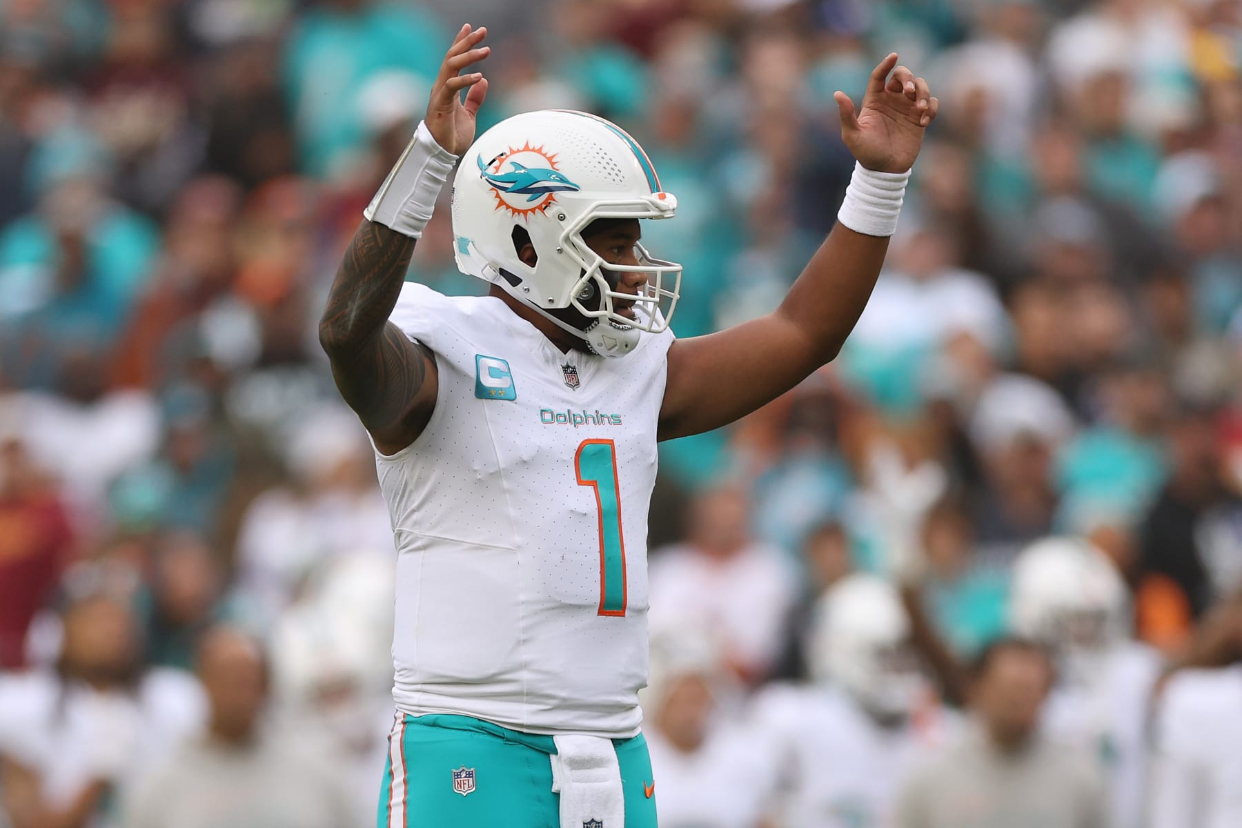 LANDOVER, MARYLAND - DECEMBER 03: Tua Tagovailoa #1 of the Miami Dolphins celebrates a touchdown against the Washington Commanders during the second quarter of the game at FedExField on December 03, 2023 in Landover, Maryland. (Photo by Patrick Smith/Getty Images)