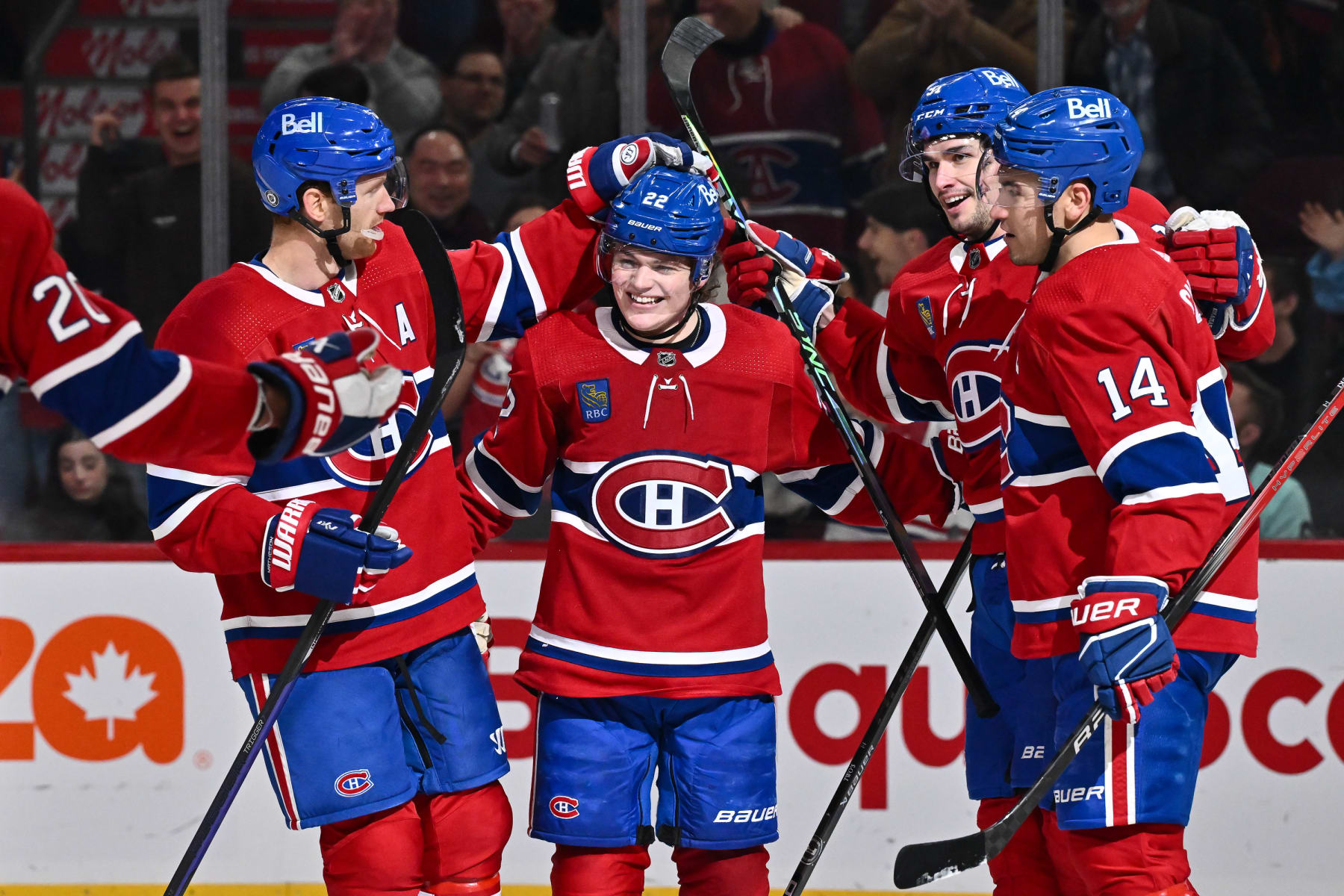 MONTREAL, CANADA - DECEMBER 04: Sean Monahan #91 of the Montreal Canadiens celebrates his goal with teammates Mike Matheson #8, Cole Caufield #22 and Nick Suzuki #14 during the second period against the Seattle Kraken at the Bell Centre on December 4, 2023 in Montreal, Quebec, Canada. (Photo by Minas Panagiotakis/Getty Images)