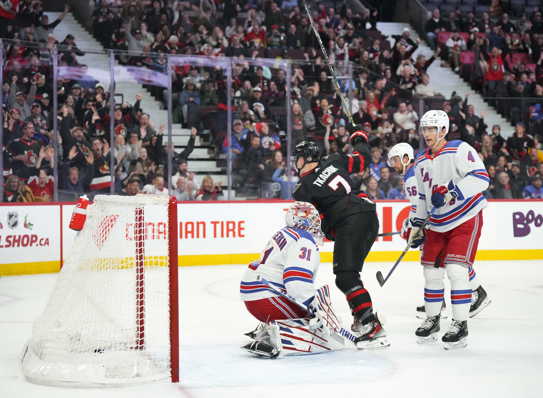 OTTAWA, CANADA - DECEMBER 5: Brady Tkachuk #7 of the Ottawa Senators celebrates his first-period goal against Igor Shesterkin #31 of the New York Rangers as Braden Schneider #4 looks on during at Canadian Tire Centre on December 5, 2023 in Ottawa, Ontario, Canada.  (Photo by André Ringuette/NHLI via Getty Images)