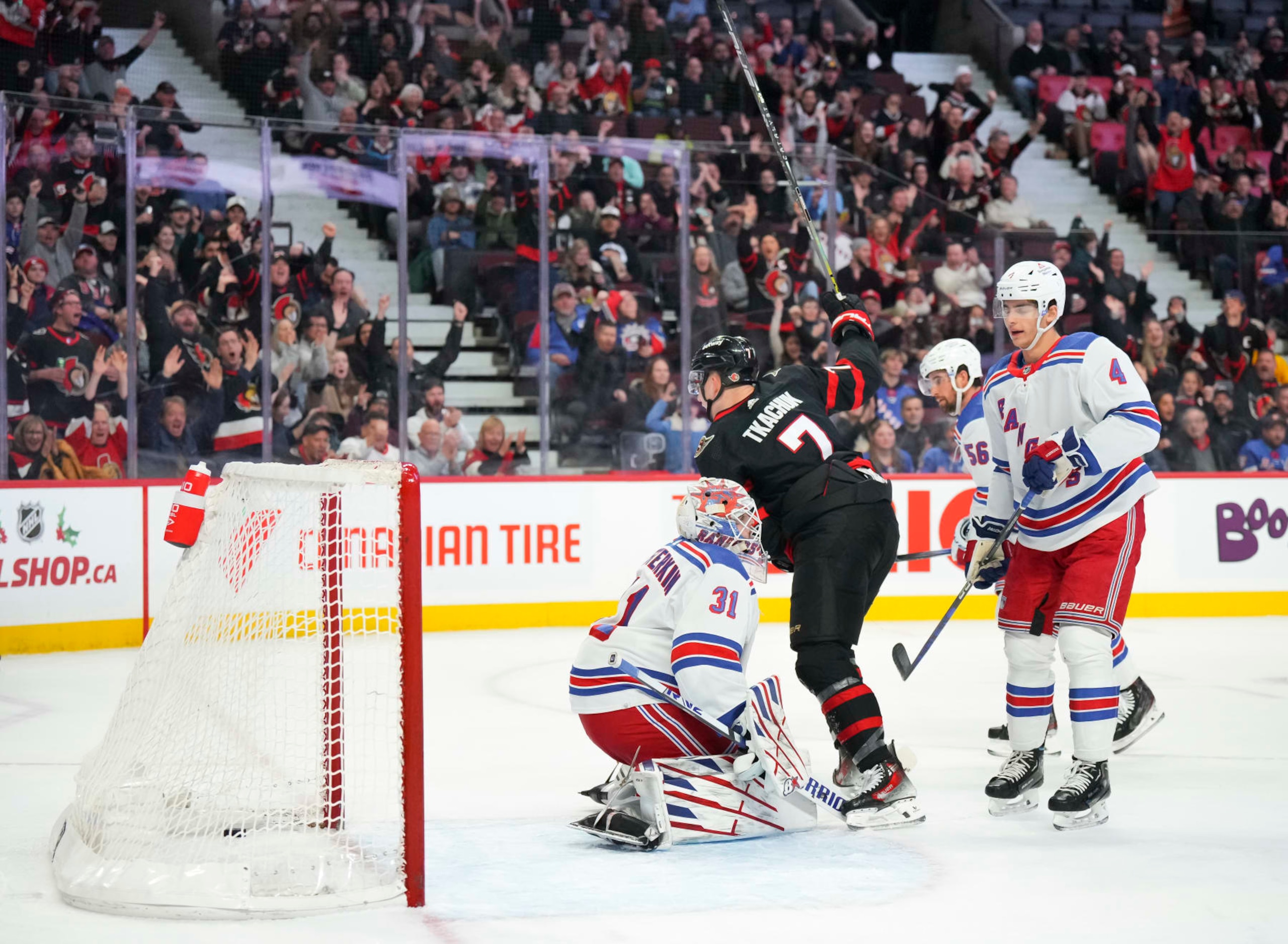 OTTAWA, CANADA - DECEMBER 5: Brady Tkachuk #7 of the Ottawa Senators celebrates his first-period goal against Igor Shesterkin #31 of the New York Rangers as Braden Schneider #4 looks on during at Canadian Tire Centre on December 5, 2023 in Ottawa, Ontario, Canada.  (Photo by André Ringuette/NHLI via Getty Images)