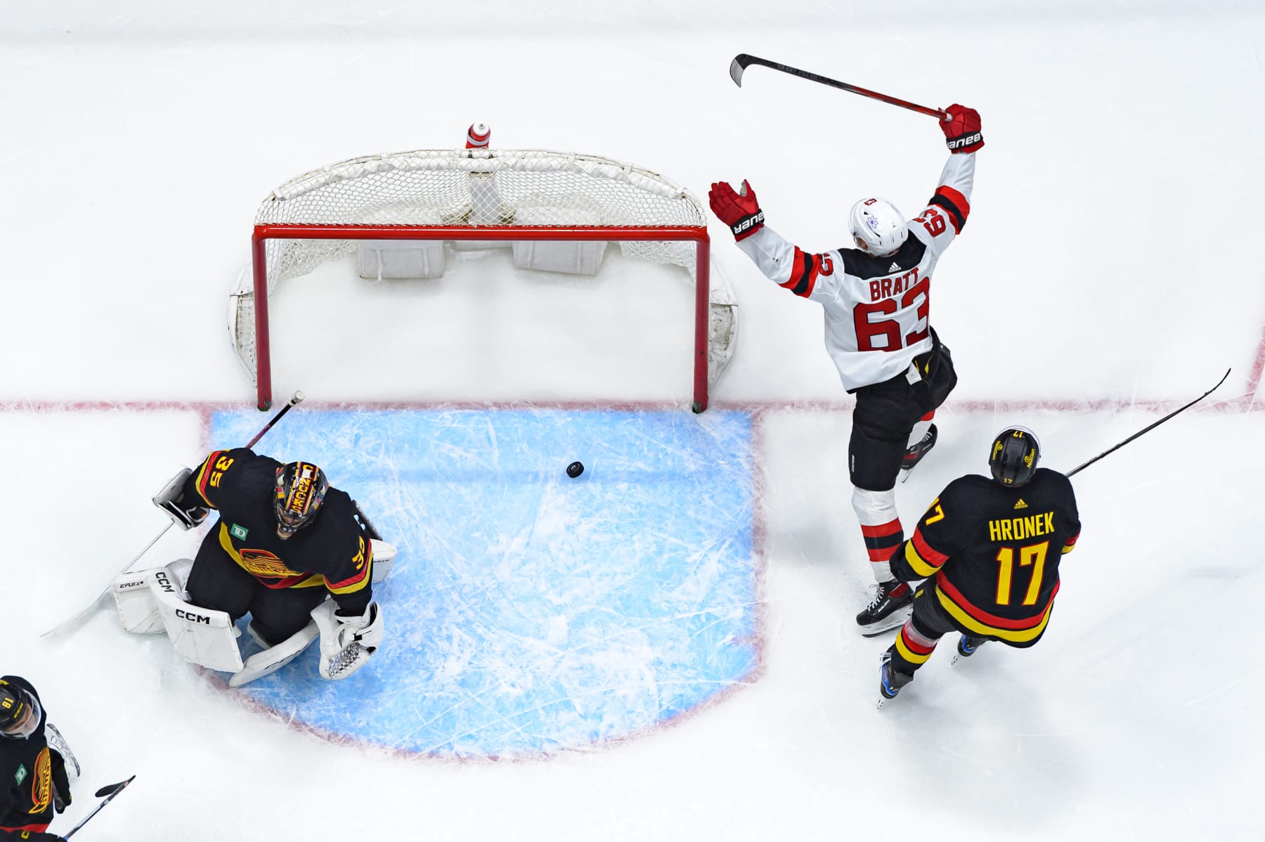 VANCOUVER, CANADA - DECEMBER 5: Jesper Bratt #63 of the New Jersey Devils celebrates after scoring the game-winning goal against Thatcher Demko #35 as Filip Hronek #17 of the Vancouver Canucks looks on during the third period of their NHL game at Rogers Arena on December 5, 2023 in Vancouver, British Columbia, Canada. (Photo by Derek Cain/Getty Images)