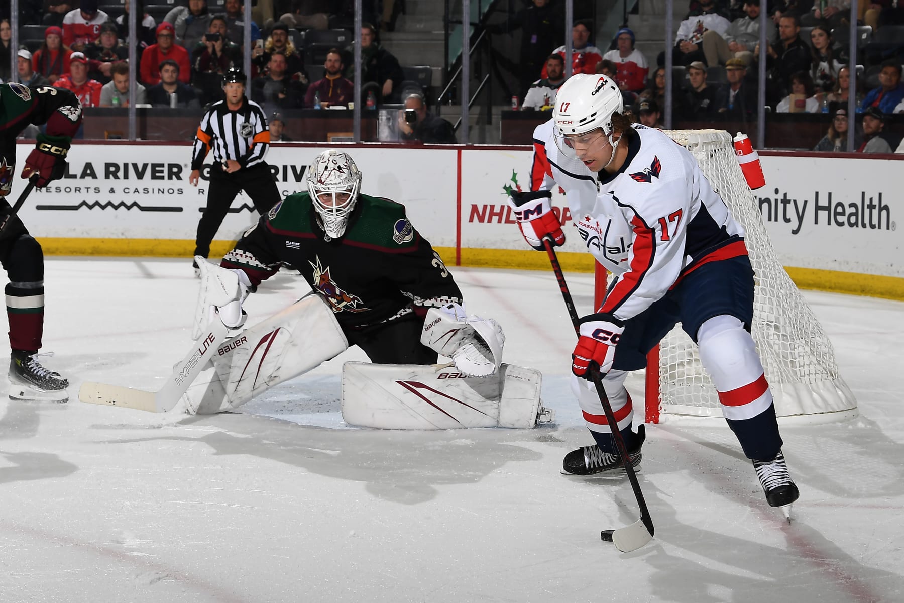 TEMPE, ARIZONA - DECEMBER 04: Dylan Strome #17 of the Washington Capitals skates with the puck as Connor Ingram #39  of the Arizona Coyotes gets ready to make a save during the second period of the game at Mullett Arena on December 04, 2023 in Tempe, Arizona. (Photo by Norm Hall/NHLI via Getty Images)