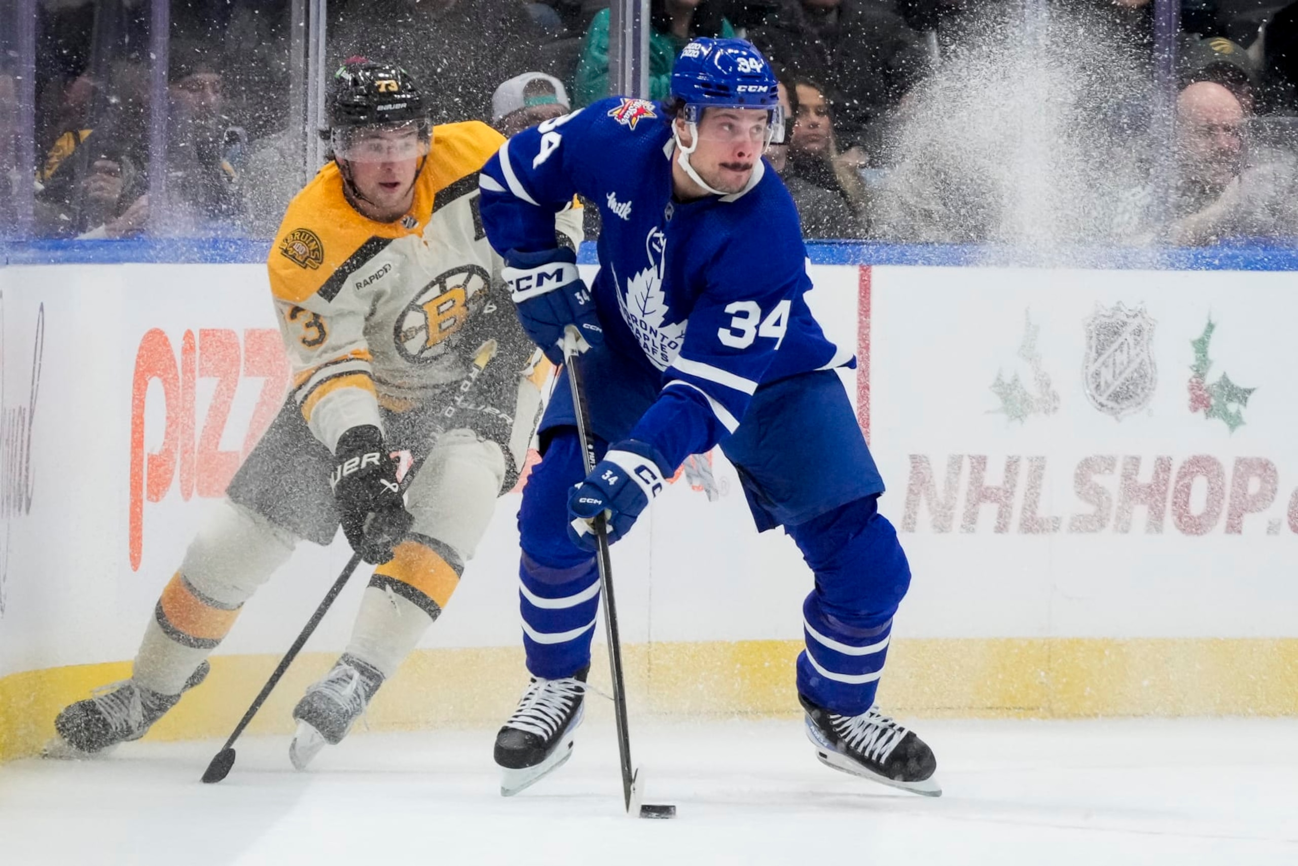 TORONTO, ON - DECEMBER 2: Auston Matthews #34 of the Toronto Maple Leafs plays the puck against Charlie McAvoy #73 of the Boston Bruins during the first period at the Scotiabank Arena on December 2, 2023 in Toronto, Ontario, Canada. (Photo by Andrew Lahodynskyj/NHLI via Getty Images)
