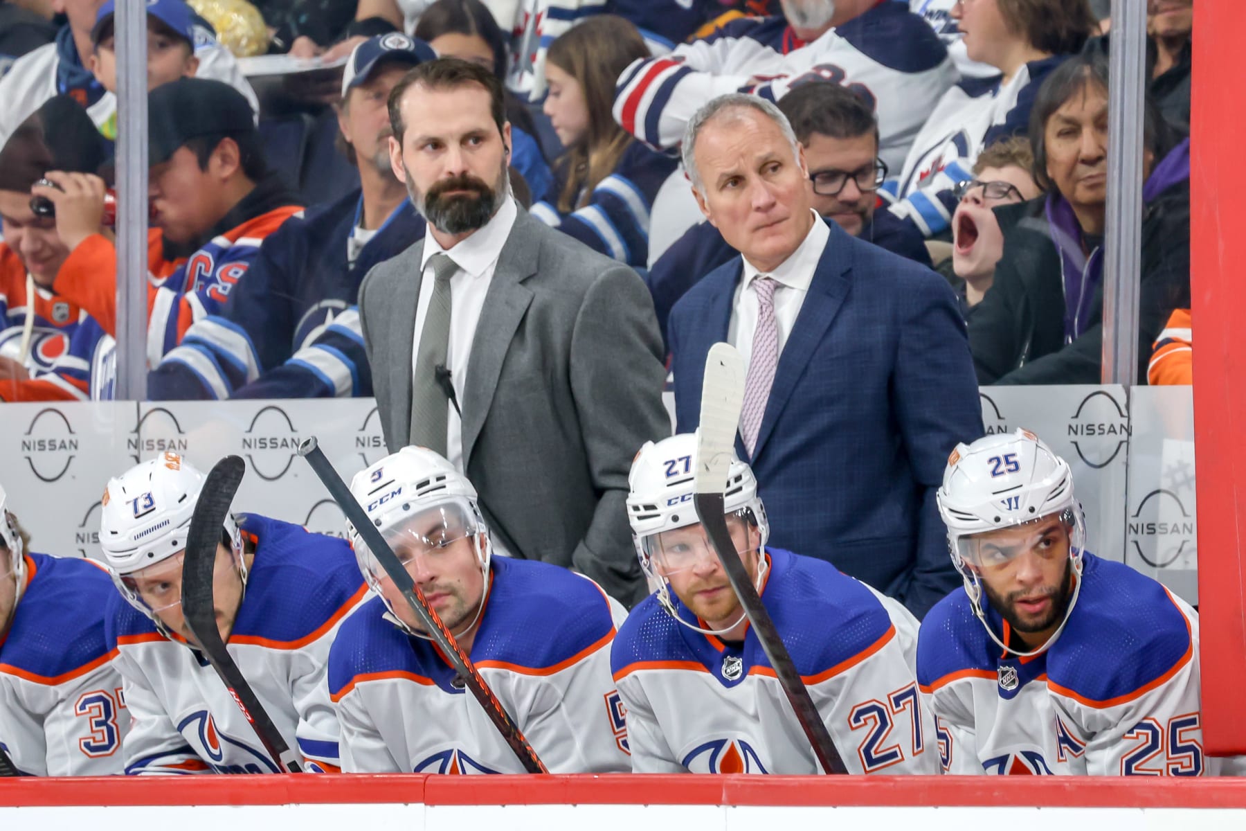 WINNIPEG, CANADA - NOVEMBER 30: Assistant Coaches Mark Stuart and Paul Coffey of the Edmonton Oilers look on from the bench during second period action against the Winnipeg Jets at the Canada Life Centre on November 30, 2023 in Winnipeg, Manitoba, Canada. (Photo by Jonathan Kozub/NHLI via Getty Images)