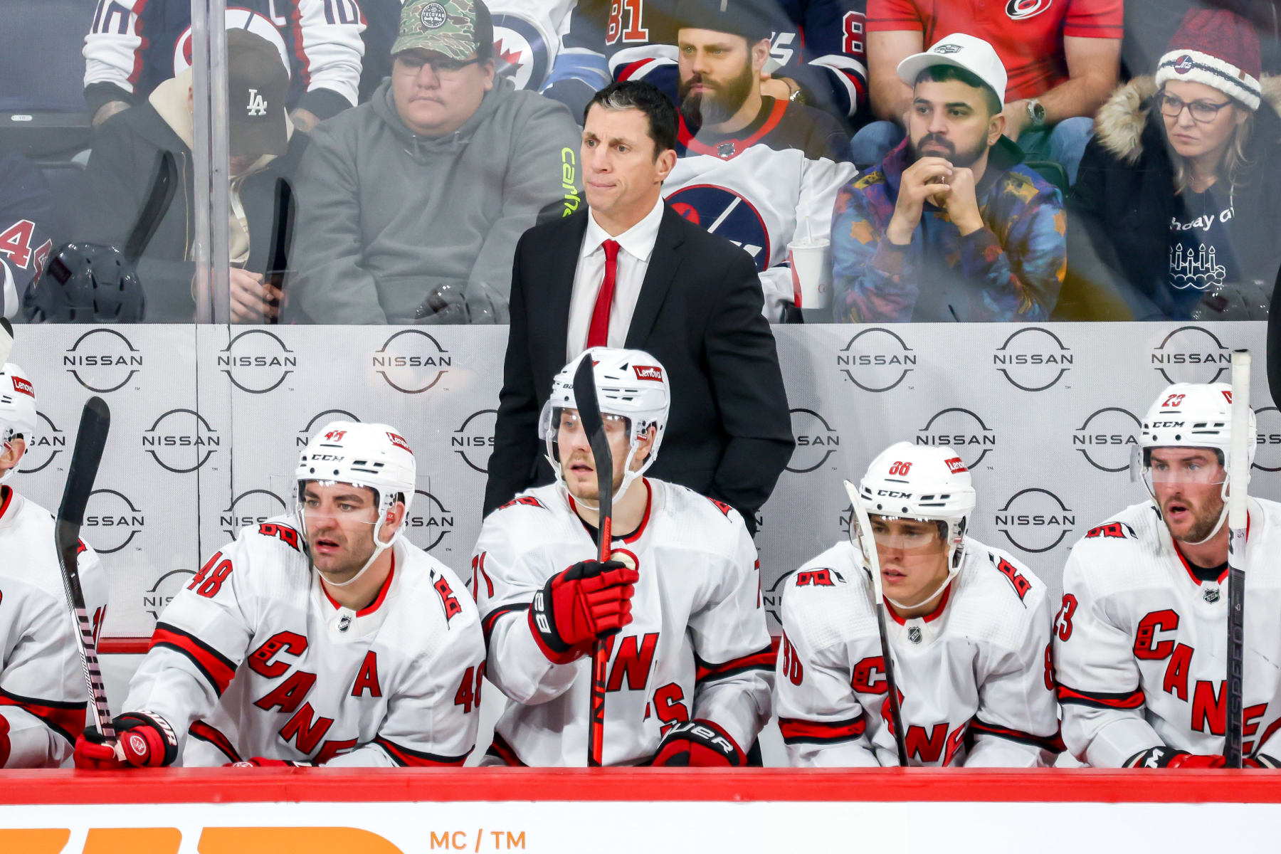 WINNIPEG, CANADA - DECEMBER 4: Head Coach Rod Brind'Amour of the Carolina Hurricanes looks on from the bench during third period action against the Winnipeg Jets at the Canada Life Centre on December 4, 2023 in Winnipeg, Manitoba, Canada. (Photo by Jonathan Kozub/NHLI via Getty Images)