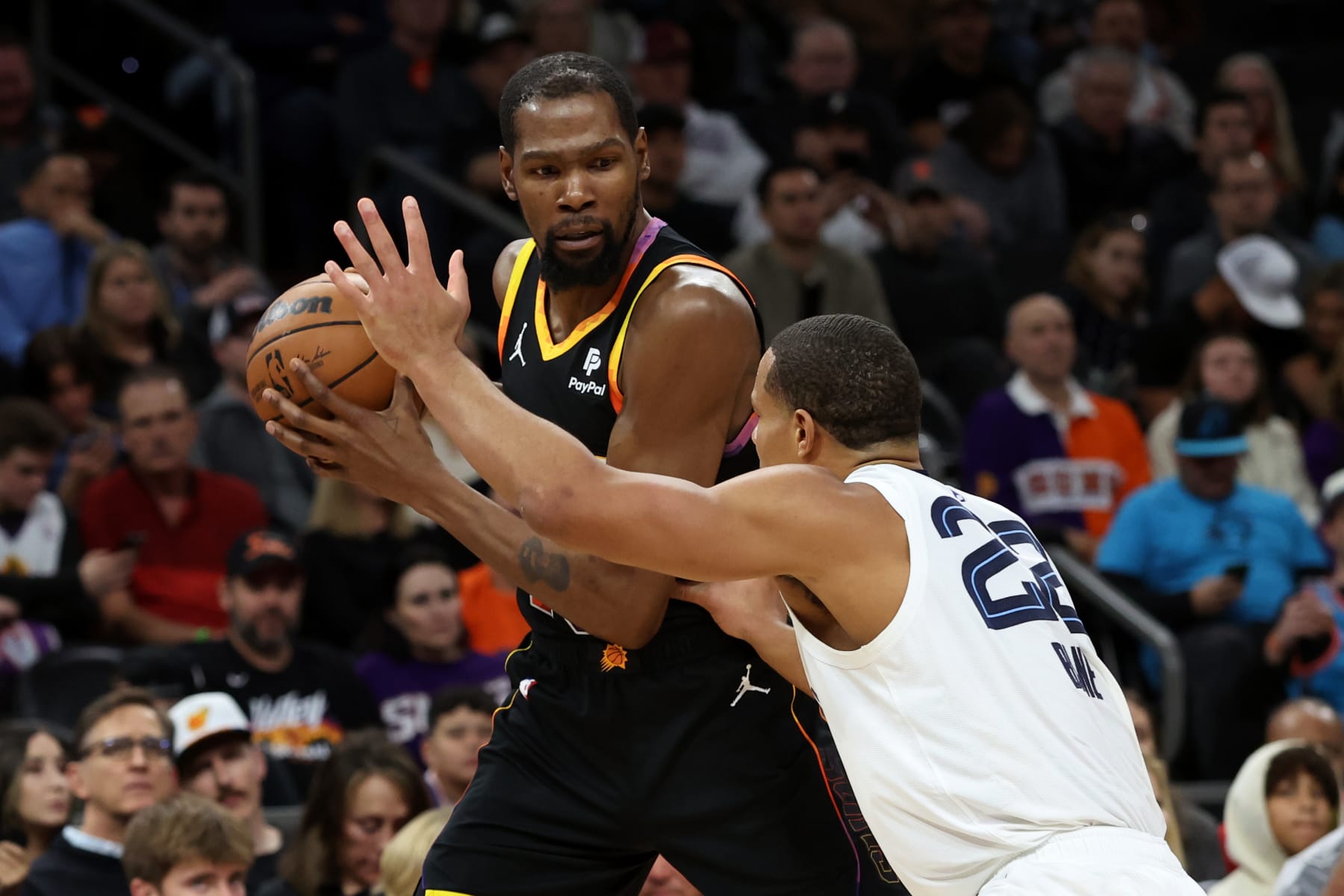PHOENIX, ARIZONA - DECEMBER 02: Kevin Durant #35 of the Phoenix Suns dribbles the ball against Desmond Bane #22 of the Memphis Grizzlies during the first quarter at Footprint Center on December 02, 2023 in Phoenix, Arizona. NOTE TO USER: User expressly acknowledges and agrees that, by downloading and or using this photograph, User is consenting to the terms and conditions of the Getty Images License Agreement. (Photo by Zac BonDurant/Getty Images)