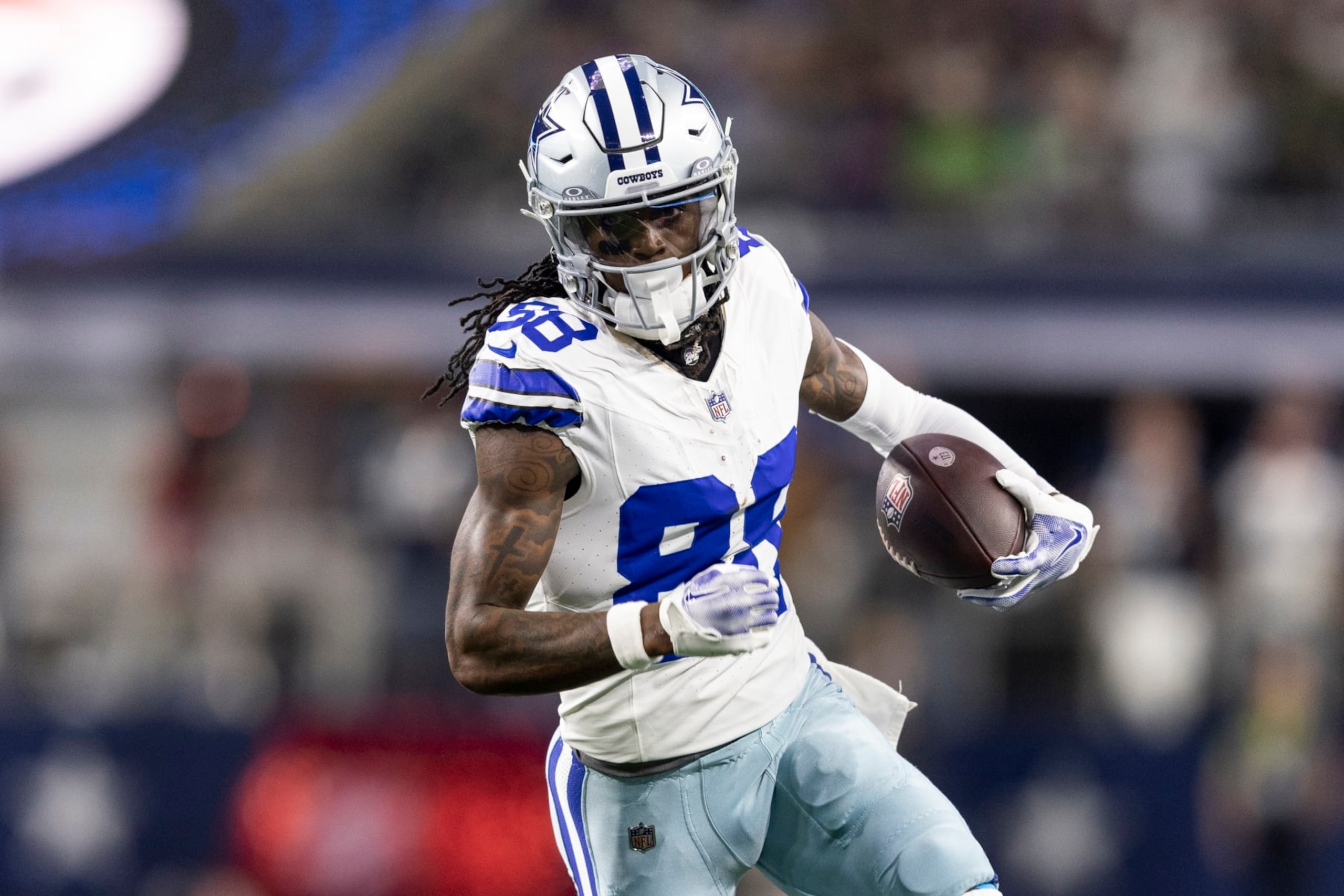 ARLINGTON, TEXAS - NOVEMBER 30: CeeDee Lamb #88 of the Dallas Cowboys runs with the ball during an NFL football game between the Dallas Cowboys and the Seattle Seahawks at AT&T Stadium on November 30, 2023 in Arlington, Texas. (Photo by Michael Owens/Getty Images)