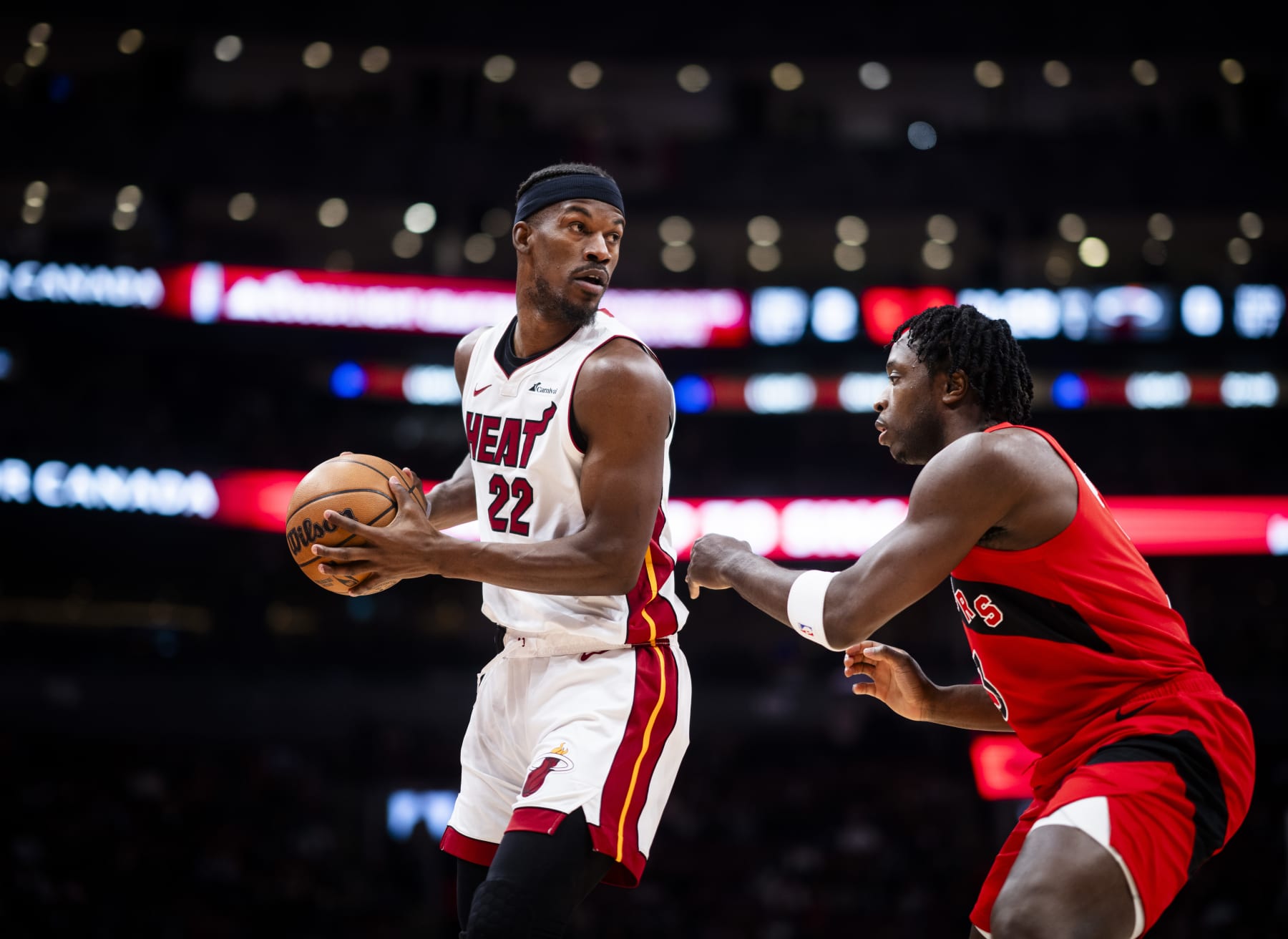 TORONTO, ON - DECEMBER 6: Jimmy Butler #22 of the Miami Heat is guarded by O.G. Anunoby #3 of the Toronto Raptors during the first half of their basketball game at the Scotiabank Arena on December 6, 2023 in Toronto, Ontario, Canada. NOTE TO USER: User expressly acknowledges and agrees that, by downloading and/or using this Photograph, user is consenting to the terms and conditions of the Getty Images License Agreement. (Photo by Mark Blinch/Getty Images)