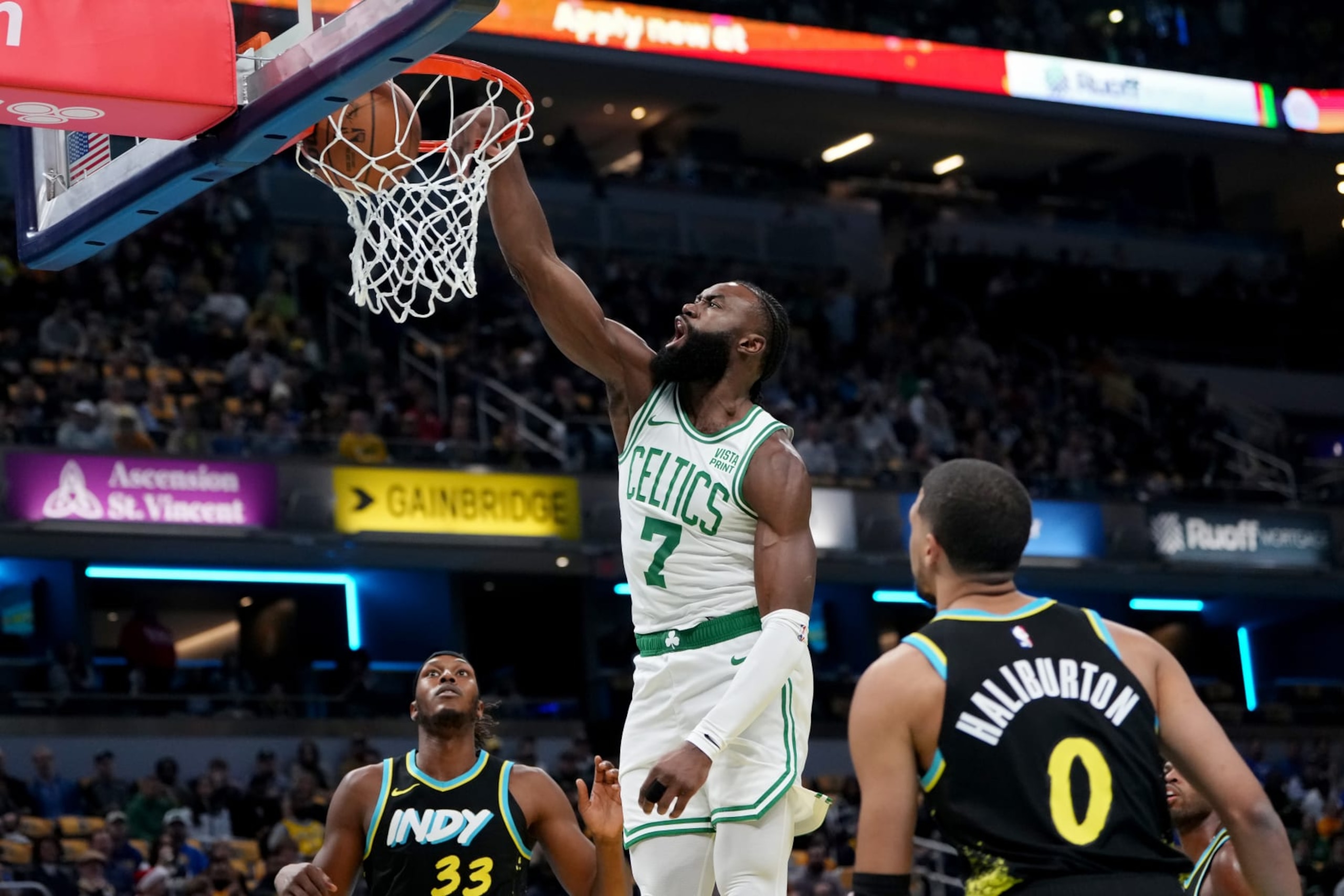 INDIANAPOLIS, INDIANA - DECEMBER 04: Jaylen Brown #7 of the Boston Celtics dunks the ball past Myles Turner #33 and Tyrese Haliburton #0 of the Indiana Pacers in the first quarter during the NBA In-Season Tournament at Gainbridge Fieldhouse on December 04, 2023 in Indianapolis, Indiana. NOTE TO USER: User expressly acknowledges and agrees that, by downloading and or using this photograph, User is consenting to the terms and conditions of the Getty Images License Agreement. (Photo by Dylan Buell/Getty Images)