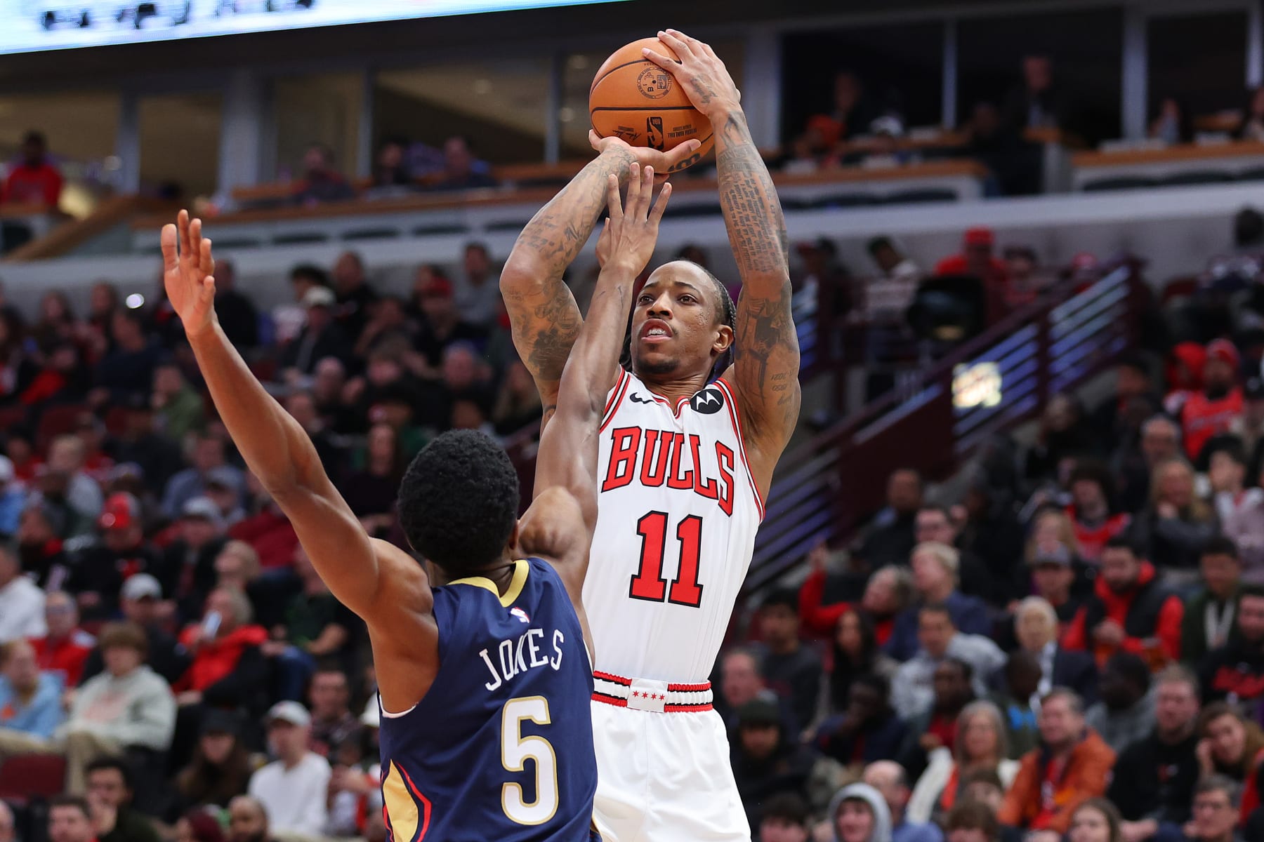 CHICAGO, ILLINOIS - DECEMBER 02: DeMar DeRozan #11 of the Chicago Bulls shoots over Herbert Jones #5 of the New Orleans Pelicans during the first half at the United Center on December 02, 2023 in Chicago, Illinois. NOTE TO USER: User expressly acknowledges and agrees that, by downloading and or using this photograph, User is consenting to the terms and conditions of the Getty Images License Agreement.  (Photo by Michael Reaves/Getty Images)
