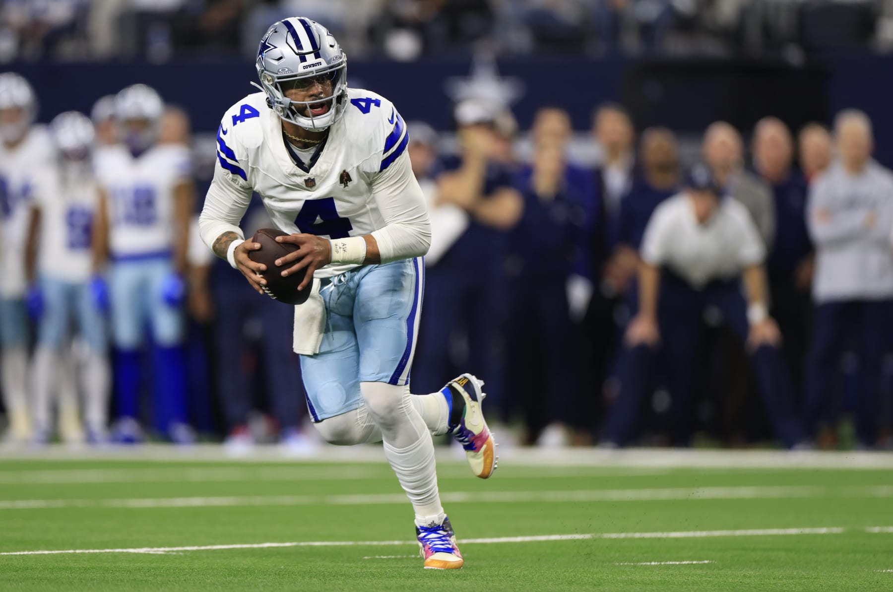 ARLINGTON, TEXAS - NOVEMBER 30: Quarterback Dak Prescott #4 of the Dallas Cowboys scrambles during the first quarter of the game against the Seattle Seahawks at AT&T Stadium on November 30, 2023 in Arlington, Texas. (Photo by Ron Jenkins/Getty Images)