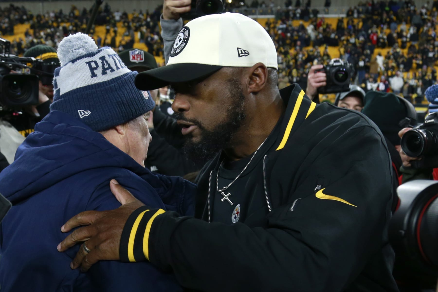 PITTSBURGH, PENNSYLVANIA - DECEMBER 07: New England Patriots head coach Bill Belichick and Pittsburgh Steelers head coach Mike Tomlin speak after the game at Acrisure Stadium on December 07, 2023 in Pittsburgh, Pennsylvania. (Photo by Justin K. Aller/Getty Images)