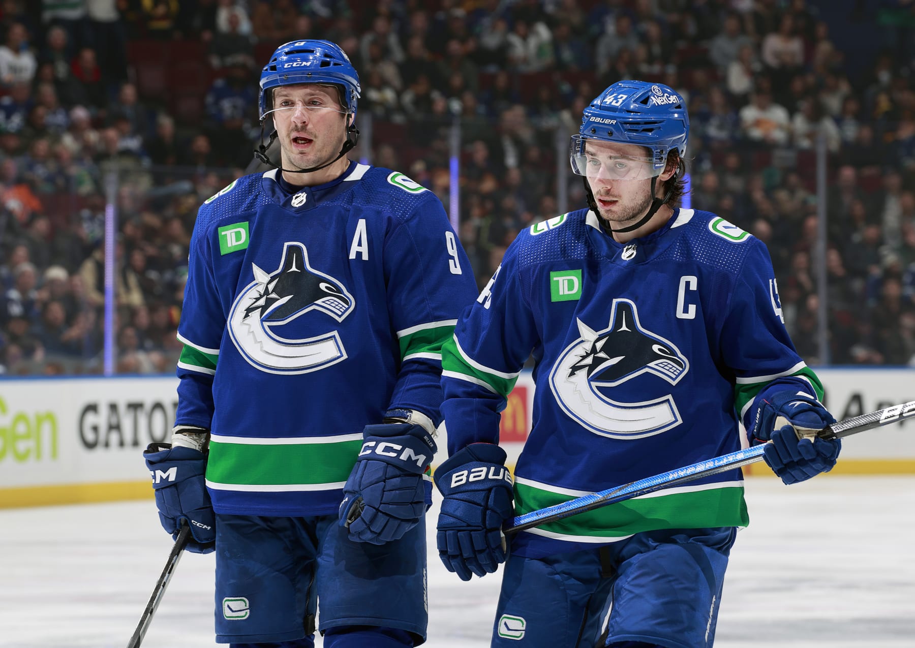 VANCOUVER, CANADA - NOVEMBER 15: Quinn Hughes #43 and J.T. Miller #9 of the Vancouver Canucks skate up ice during their NHL game against the New York Islanders at Rogers Arena on November 15, 2023 in Vancouver, British Columbia, Canada.  (Photo by Jeff Vinnick/NHLI via Getty Images)