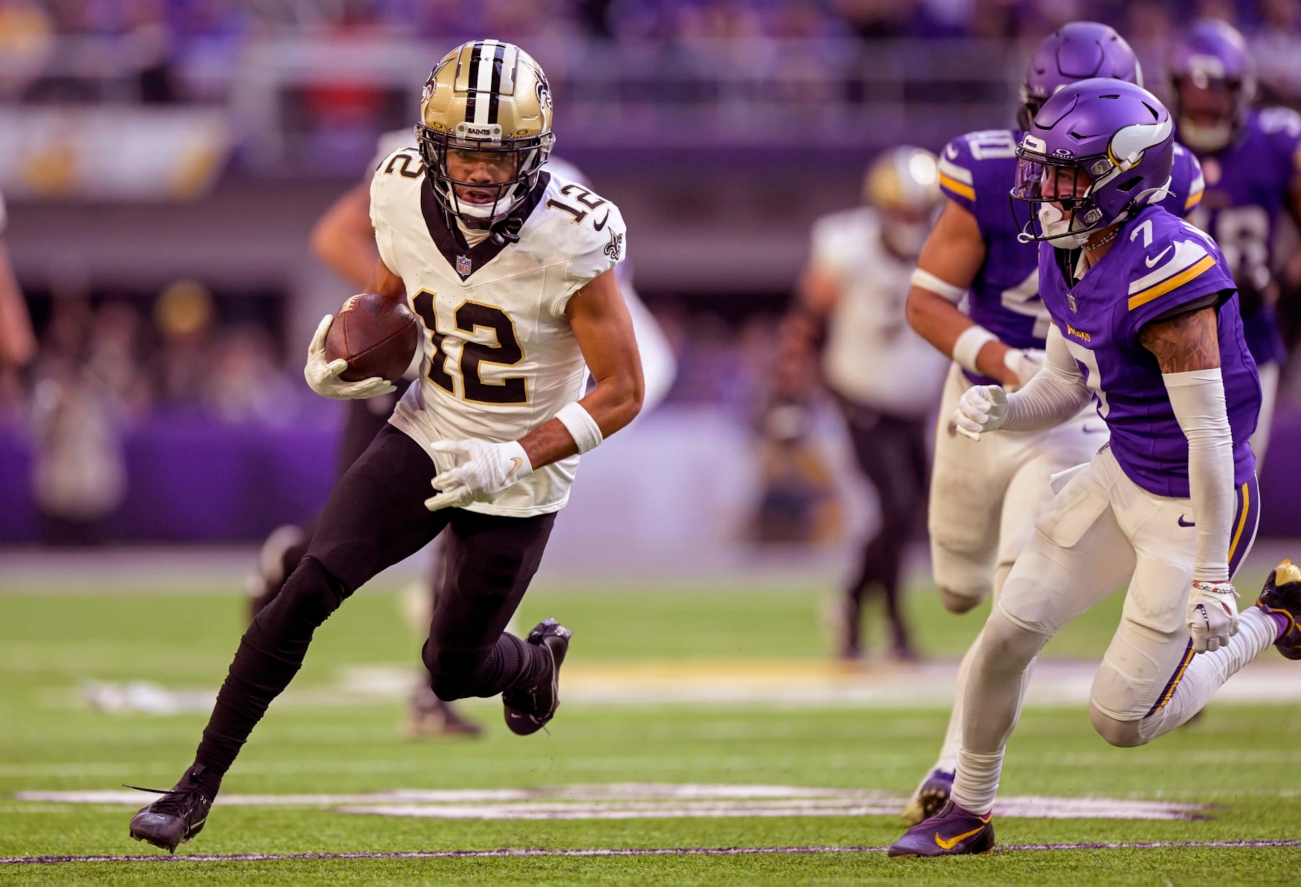 MINNEAPOLIS, MN - NOVEMBER 12: New Orleans Saints wide receiver Chris Olave (12) runs with the ball as Minnesota Vikings defensive back Byron Murphy (7) gives chase during the fourth quarter of an NFL game between the Minnesota Vikings and New Orleans Saints on November 12, 2023, at U.S. Bank Stadium in Minneapolis, MN. (Photo by Nick Wosika/Icon Sportswire via Getty Images) MINNEAPOLIS, MN - NOVEMBER 12: New Orleans Saints wide receiver Chris Olave (12) runs with the ball as Minnesota Vikings defensive back Byron Murphy (7) gives chase during the fourth quarter of an NFL game between the Minnesota Vikings and New Orleans Saints on November 12, 2023, at U.S. Bank Stadium in Minneapolis, MN. (Photo by Nick Wosika/Icon Sportswire via Getty Images)