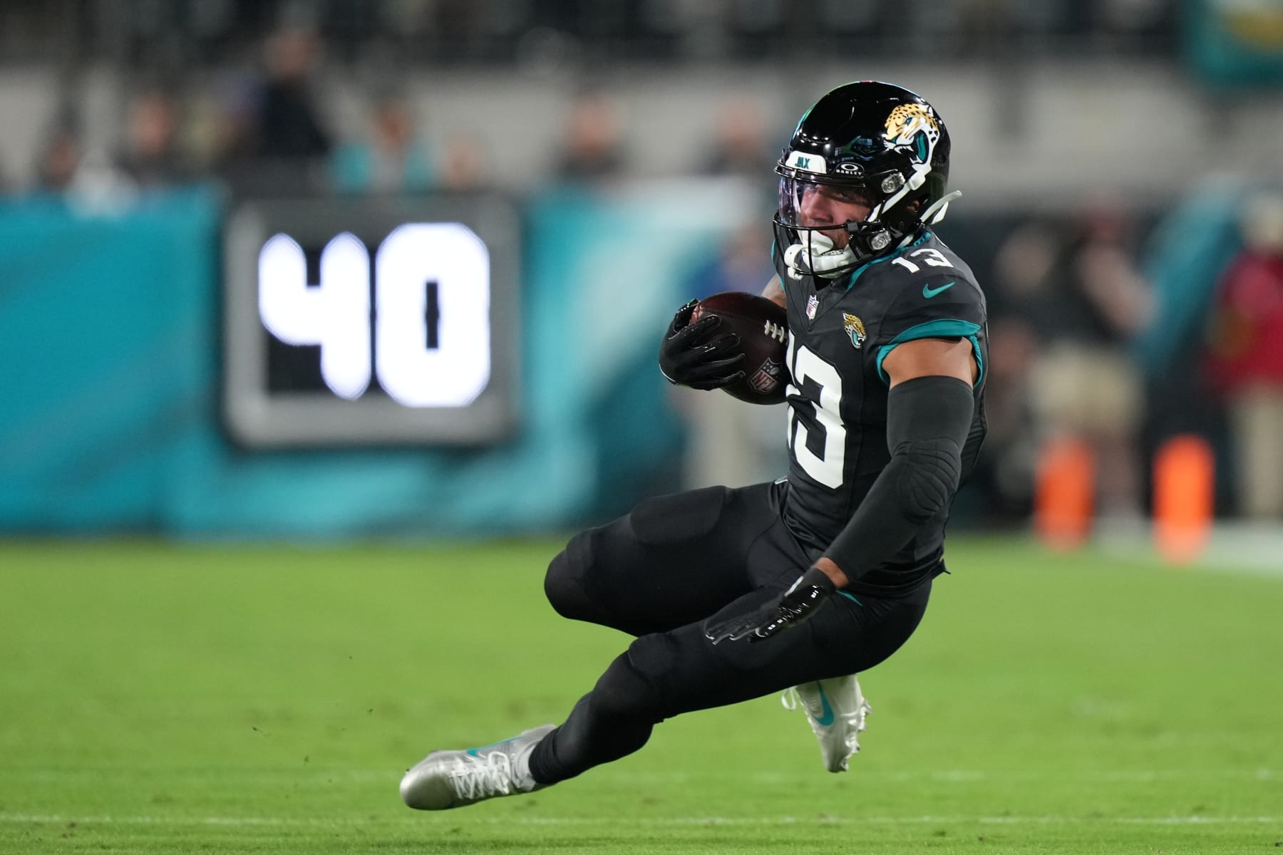 JACKSONVILLE, FL - DECEMBER 04: Jacksonville Jaguars wide receiver Christian Kirk (13) falls awkwardly after making a catch in the first half during the game between the Cincinnati Bengals and the Jacksonville Jaguars on Monday, December 4, 2023, EverBank Stadium, Jacksonville, Fla. (Photo by Peter Joneleit/Icon Sportswire via Getty Images)