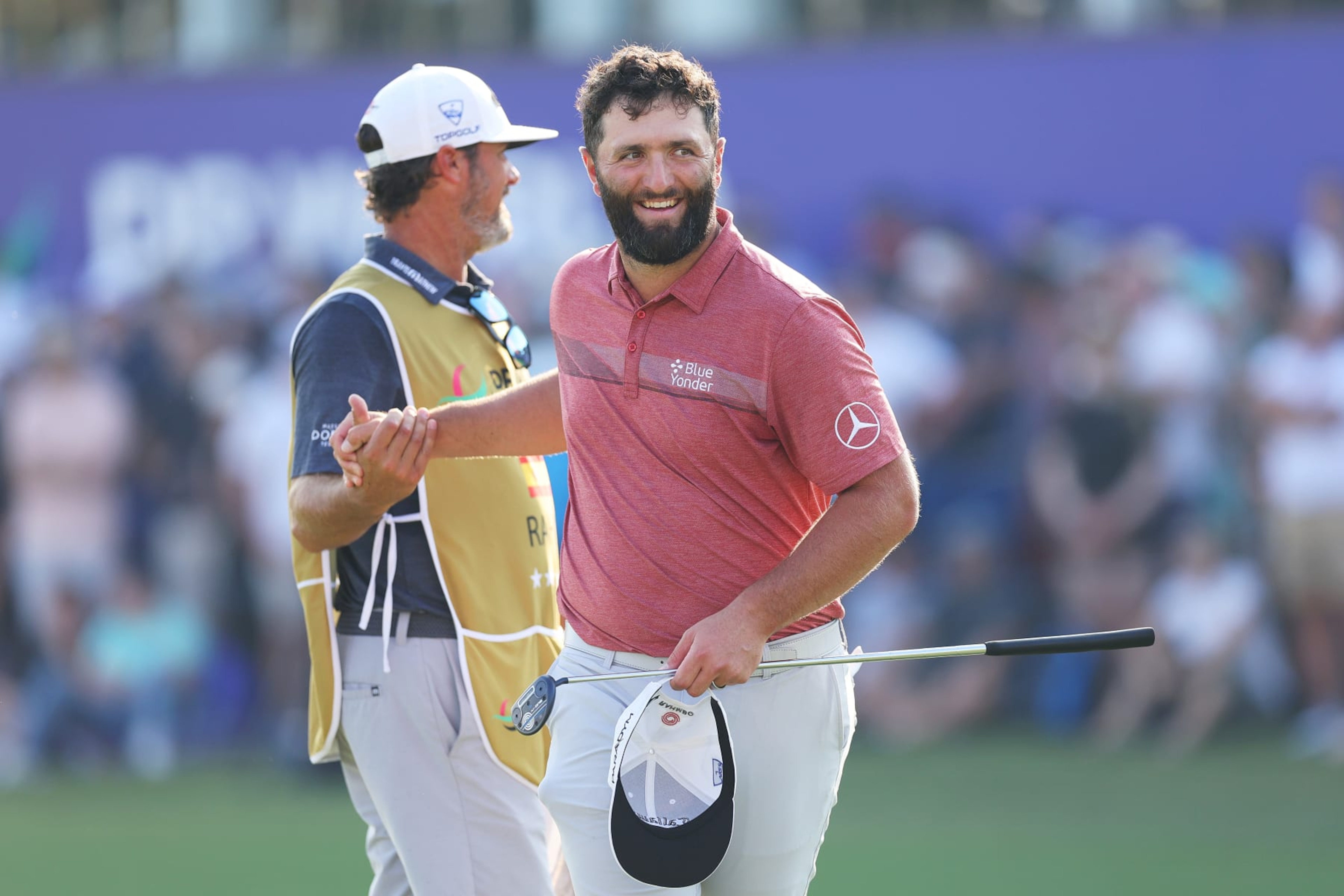 DUBAI, UNITED ARAB EMIRATES - NOVEMBER 19: Jon Rahm of Spain shakes hands with his caddie, Adam Hayes (obscured) on the 18th green during Day Four of the DP World Tour Championship on the Earth Course at Jumeirah Golf Estates on November 19, 2023 in Dubai, United Arab Emirates. (Photo by Andrew Redington/Getty Images) DUBAI, UNITED ARAB EMIRATES - NOVEMBER 19: Jon Rahm of Spain shakes hands with his caddie, Adam Hayes (obscured) on the 18th green during Day Four of the DP World Tour Championship on the Earth Course at Jumeirah Golf Estates on November 19, 2023 in Dubai, United Arab Emirates. (Photo by Andrew Redington/Getty Images)