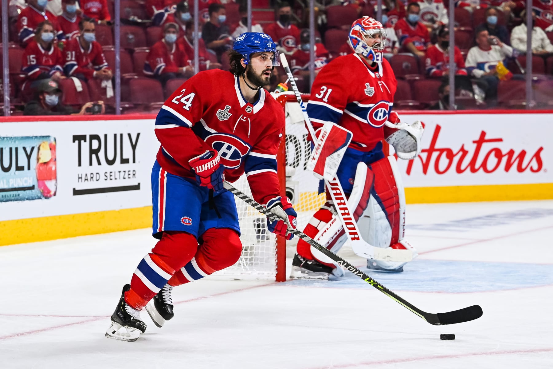 MONTREAL, QC - JULY 02: Montreal Canadiens center Phillip Danault (24) considers his options with the puck during the NHL Stanley Cup Playoffs Final game 3 between the Tampa Bay Lightning versus the Montreal Canadiens on July 02, 2021, at Bell Centre in Montreal, QC (Photo by David Kirouac/Icon Sportswire via Getty Images)