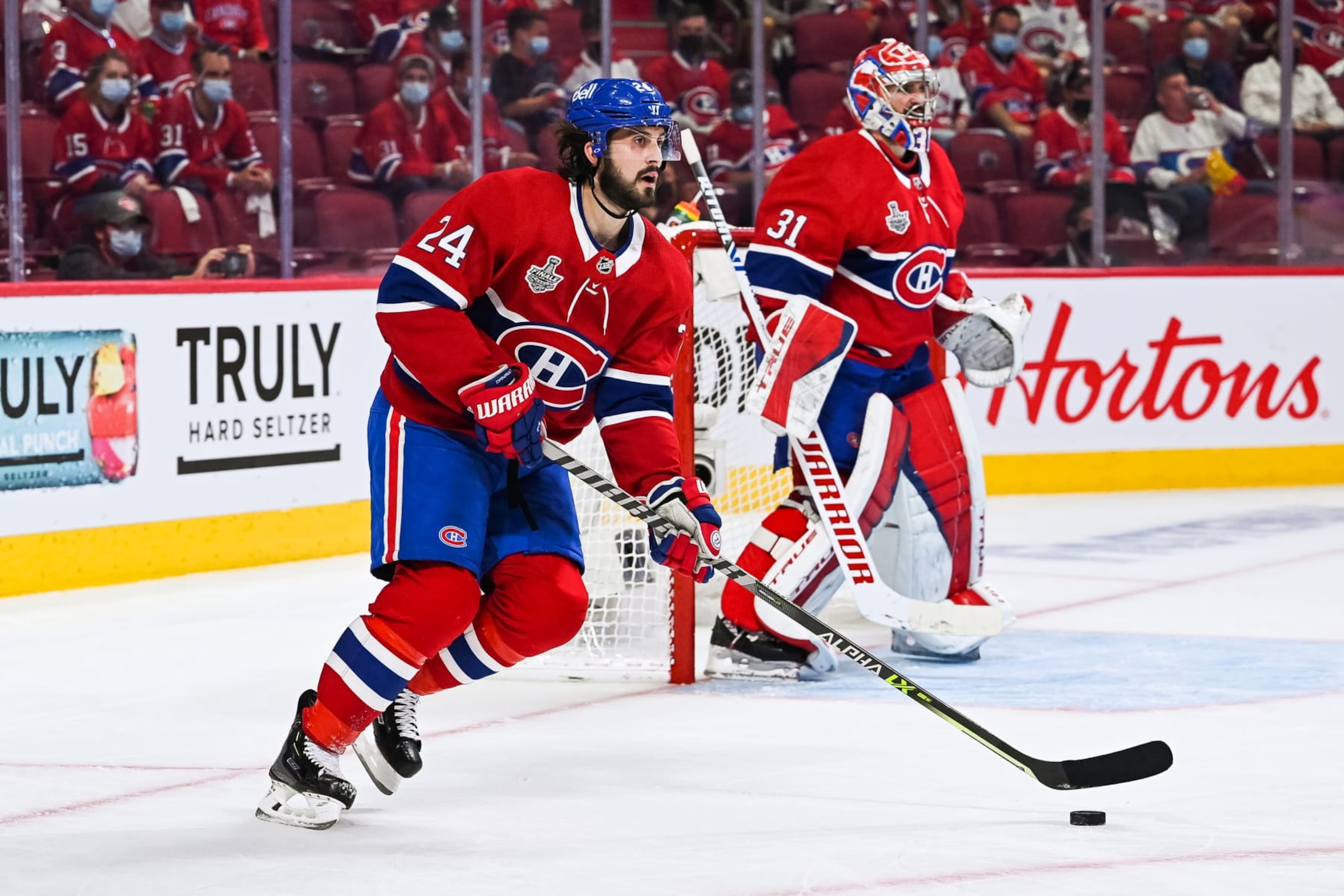 MONTREAL, QC - JULY 02: Montreal Canadiens center Phillip Danault (24) considers his options with the puck during the NHL Stanley Cup Playoffs Final game 3 between the Tampa Bay Lightning versus the Montreal Canadiens on July 02, 2021, at Bell Centre in Montreal, QC (Photo by David Kirouac/Icon Sportswire via Getty Images)