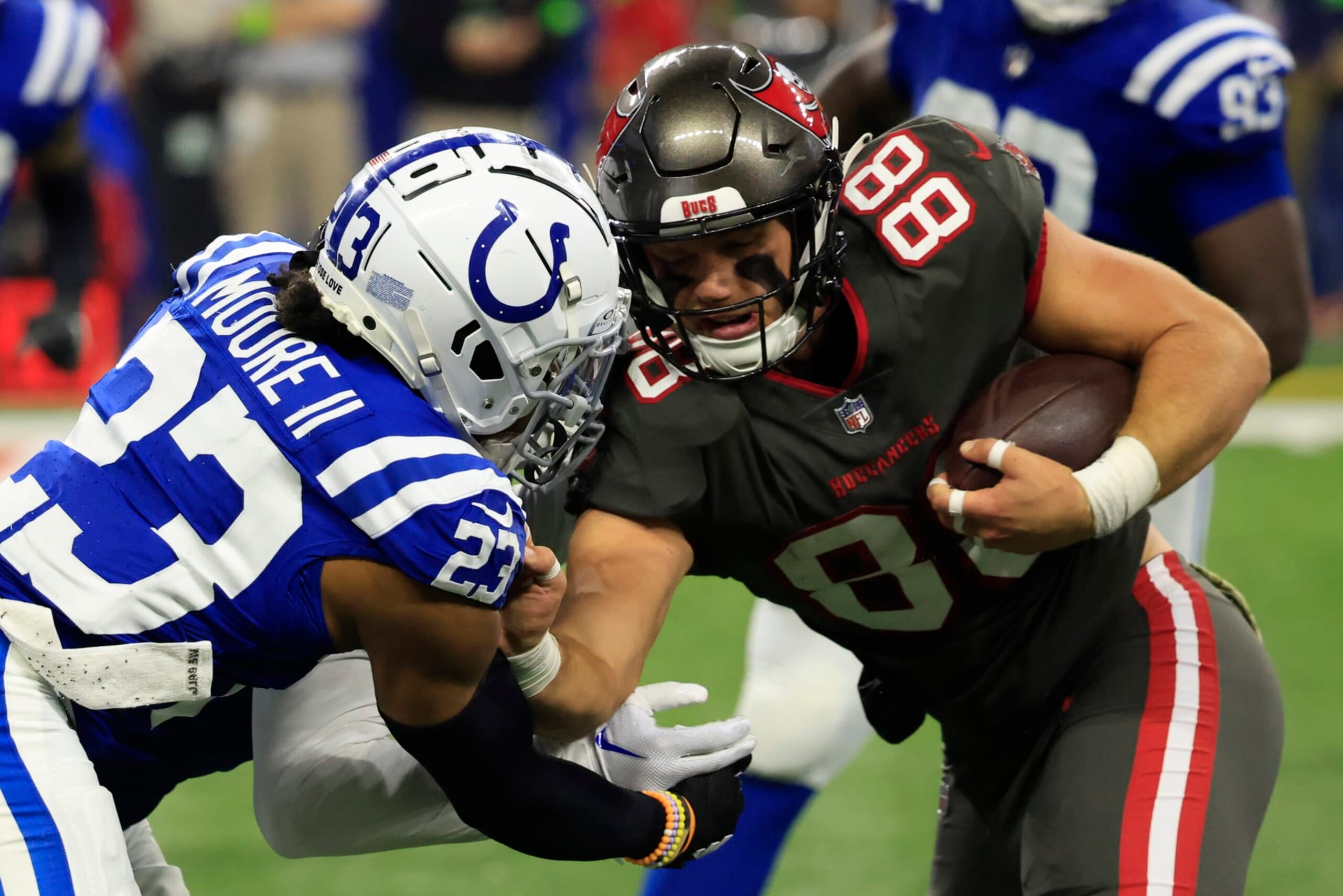 INDIANAPOLIS, INDIANA - NOVEMBER 26: Cade Otton #88 of the Tampa Bay Buccaneers is tackled by Kenny Moore II #23 of the Indianapolis Colts at Lucas Oil Stadium on November 26, 2023 in Indianapolis, Indiana. (Photo by Justin Casterline/Getty Images)