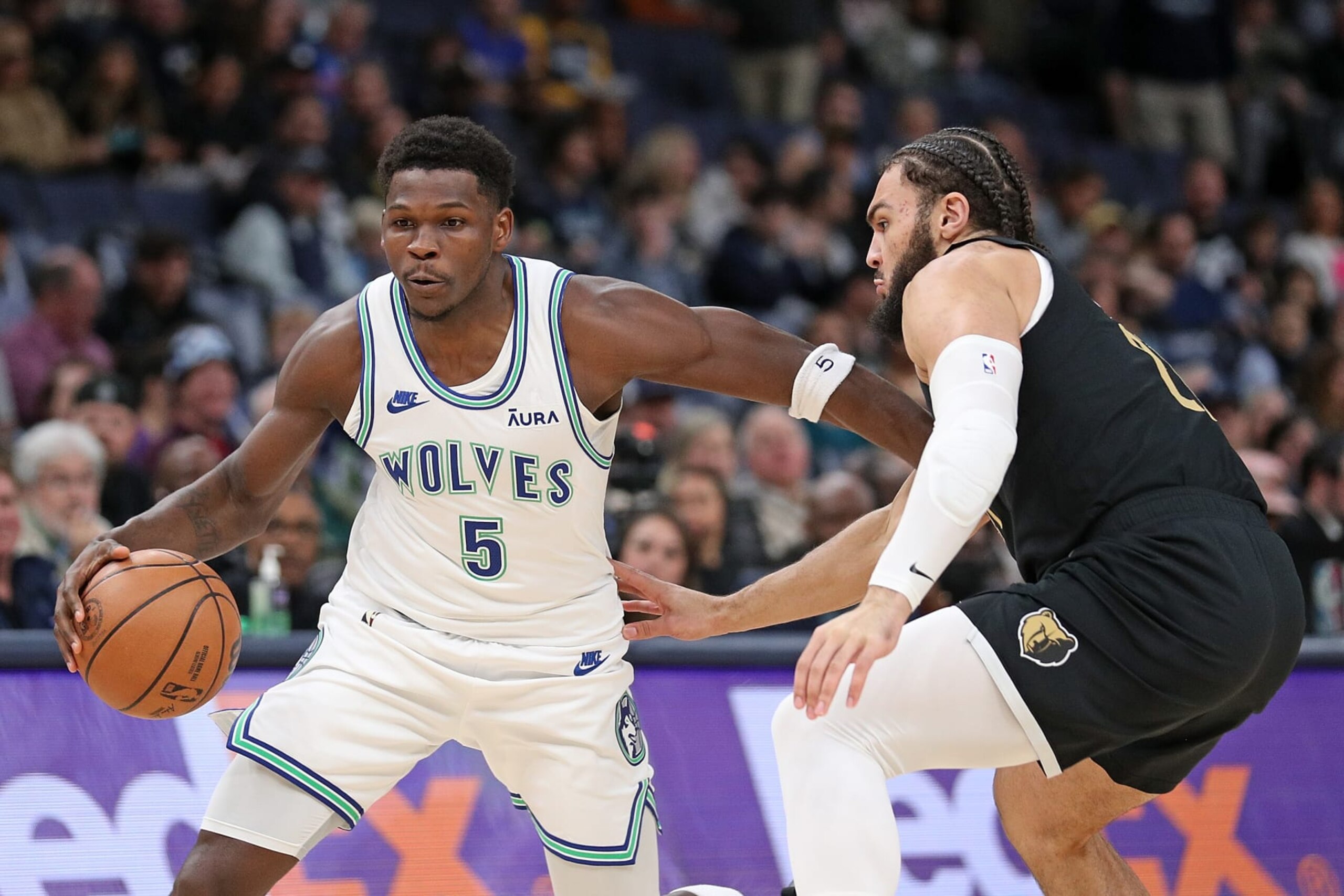 MEMPHIS, TENNESSEE - DECEMBER 08: Anthony Edwards #5 of the Minnesota Timberwolves handles the ball against David Roddy #21 of the Memphis Grizzlies during the first half at FedExForum on December 08, 2023 in Memphis, Tennessee. NOTE TO USER: User expressly acknowledges and agrees that, by downloading and or using this photograph, User is consenting to the terms and conditions of the Getty Images License Agreement.  (Photo by Justin Ford/Getty Images)