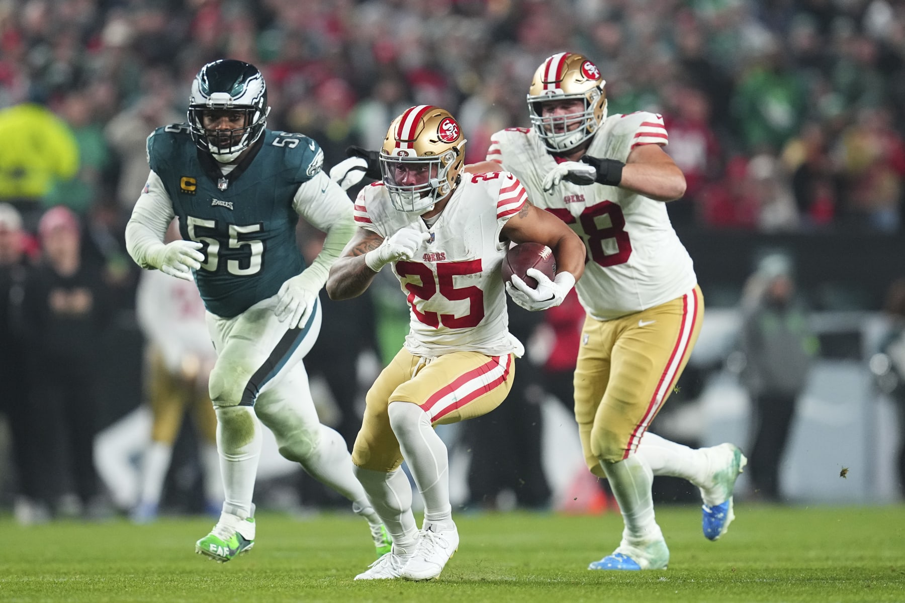 PHILADELPHIA, PENNSYLVANIA - DECEMBER 3: Elijah Mitchell #25 of the San Francisco 49ers runs the ball against Brandon Graham #55 of the Philadelphia Eagles at Lincoln Financial Field on December 3, 2023 in Philadelphia, Pennsylvania. (Photo by Mitchell Leff/Getty Images)