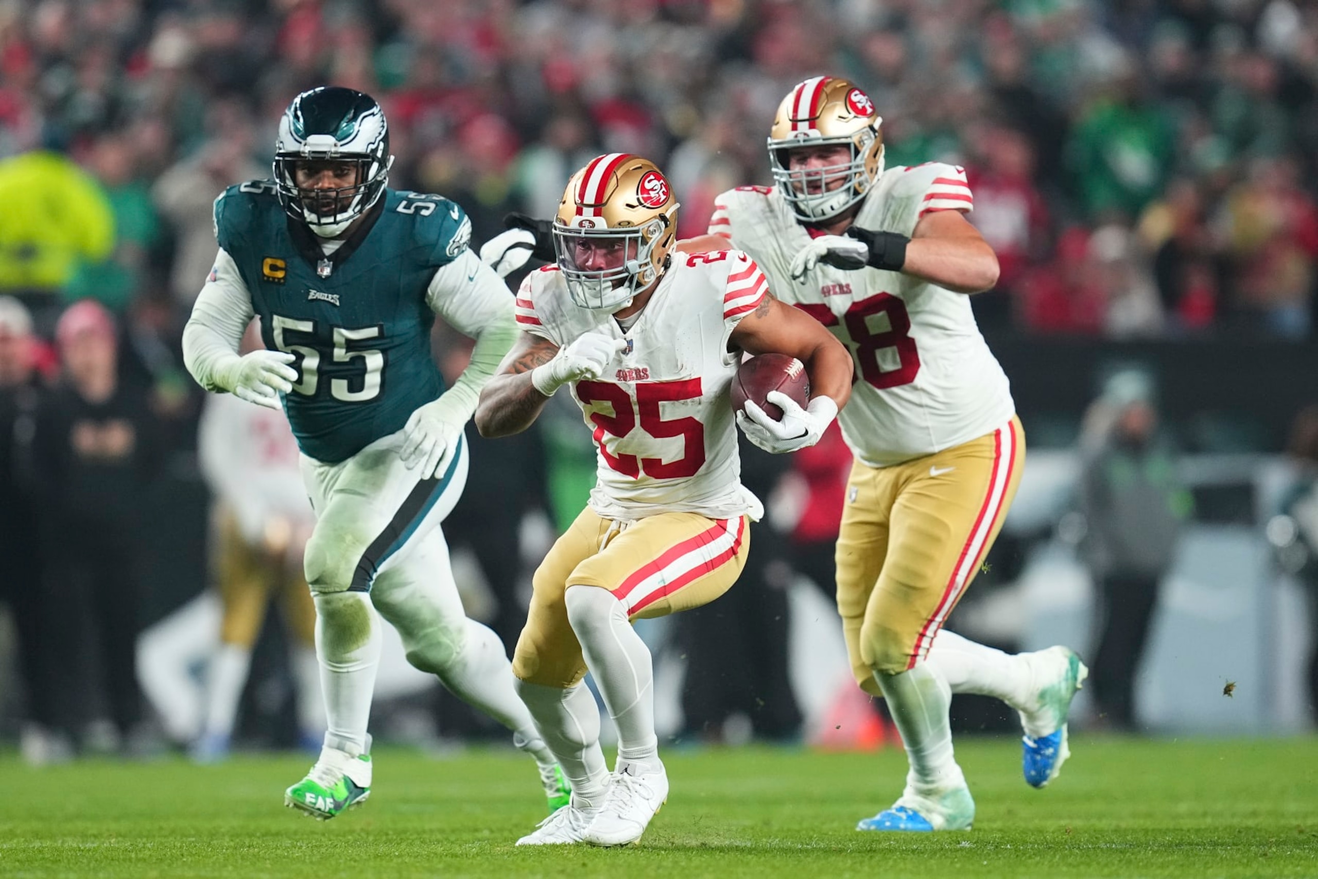 PHILADELPHIA, PENNSYLVANIA - DECEMBER 3: Elijah Mitchell #25 of the San Francisco 49ers runs the ball against Brandon Graham #55 of the Philadelphia Eagles at Lincoln Financial Field on December 3, 2023 in Philadelphia, Pennsylvania. (Photo by Mitchell Leff/Getty Images)