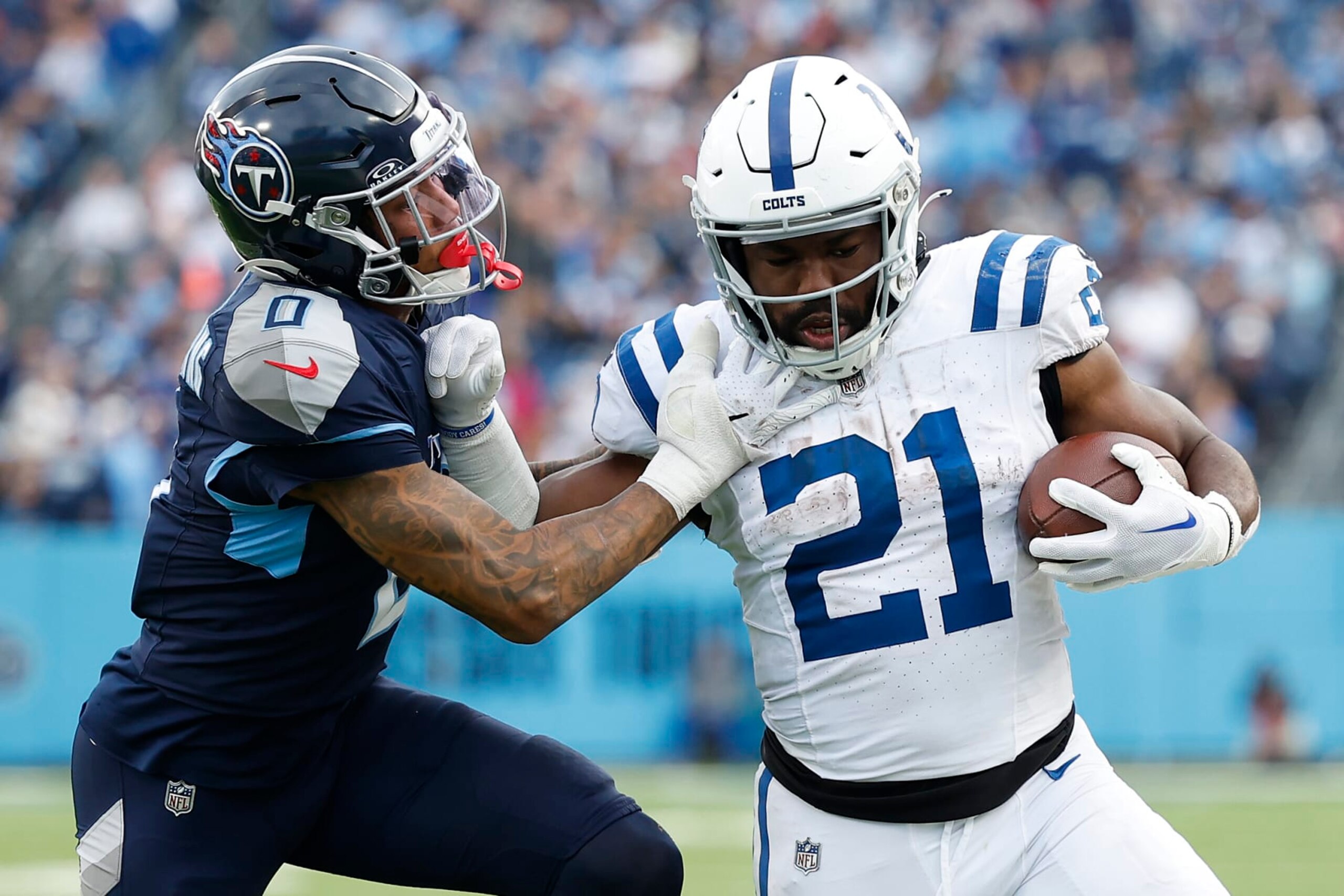 NASHVILLE, TENNESSEE - DECEMBER 03: Zack Moss #21 of the Indianapolis Colts carries the ball against Sean Murphy-Bunting #0 of the Tennessee Titans during the second half at Nissan Stadium on December 03, 2023 in Nashville, Tennessee. (Photo by Wesley Hitt/Getty Images)