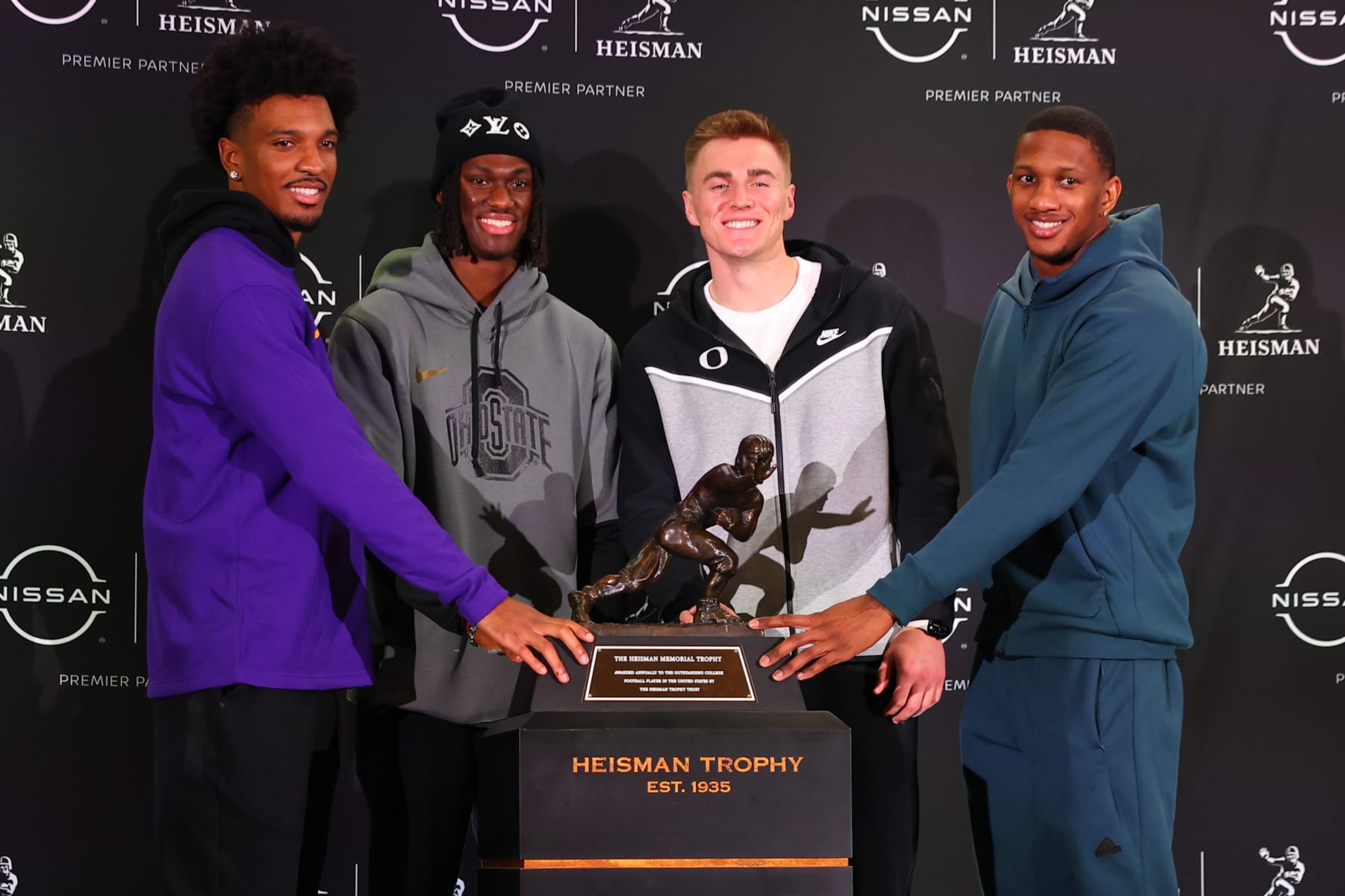 NEW YORK, NY - DECEMBER 08:  Jayden Daniels quarterback LSU, Marvin Harrison Jr. wide receiver from Ohio State,  Bo Nix quarterback, Oregon, Michael Penix Jr, quarterback, Washington pose for a photo with the Heisman Trophy during the Heisman Trophy press conference at the New York Marriott Marquis on December 8, 2023 in New York City, New York.  (Photo by Rich Graessle/Icon Sportswire via Getty Images)