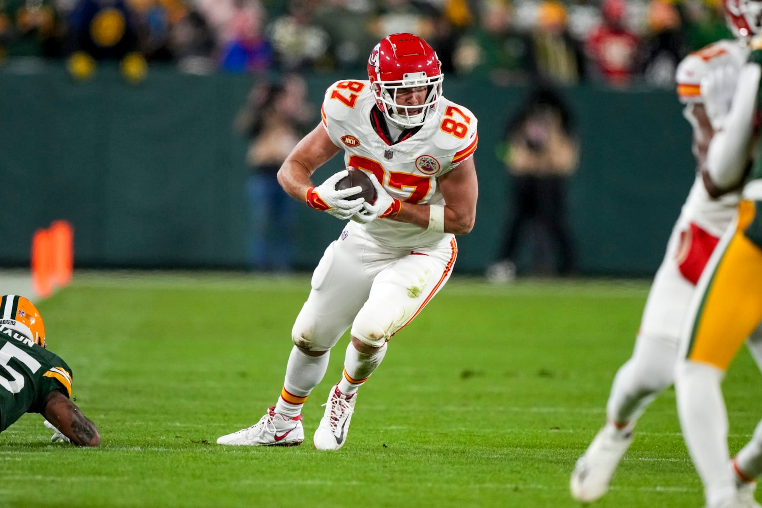 GREEN BAY, WI - DECEMBER 3: Tight end Travis Kelce #87 of the Kansas City Chiefs runs the ball during an NFL football game against the Green Bay Packers at Lambeau Field on December 3, 2023 in Green Bay, Wisconsin. (Photo by Todd Rosenberg/Getty Images)