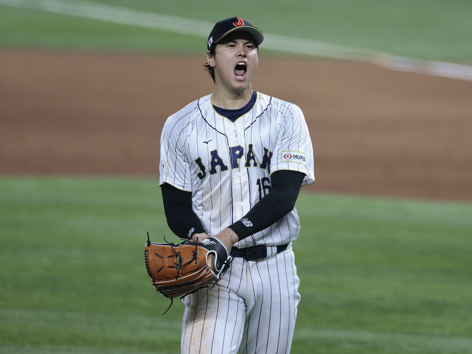 MIAMI, FL - MARCH 21:  Shohei Ohtani #16 of Team Japan reacts after the final out in the top of the 9th inning to defeat Team USA 3-2 during World Baseball Classic Championship at loanDepot park on March 21, 2023 in Miami, Florida. (Photo by Christopher Pasatieri/Getty Images)