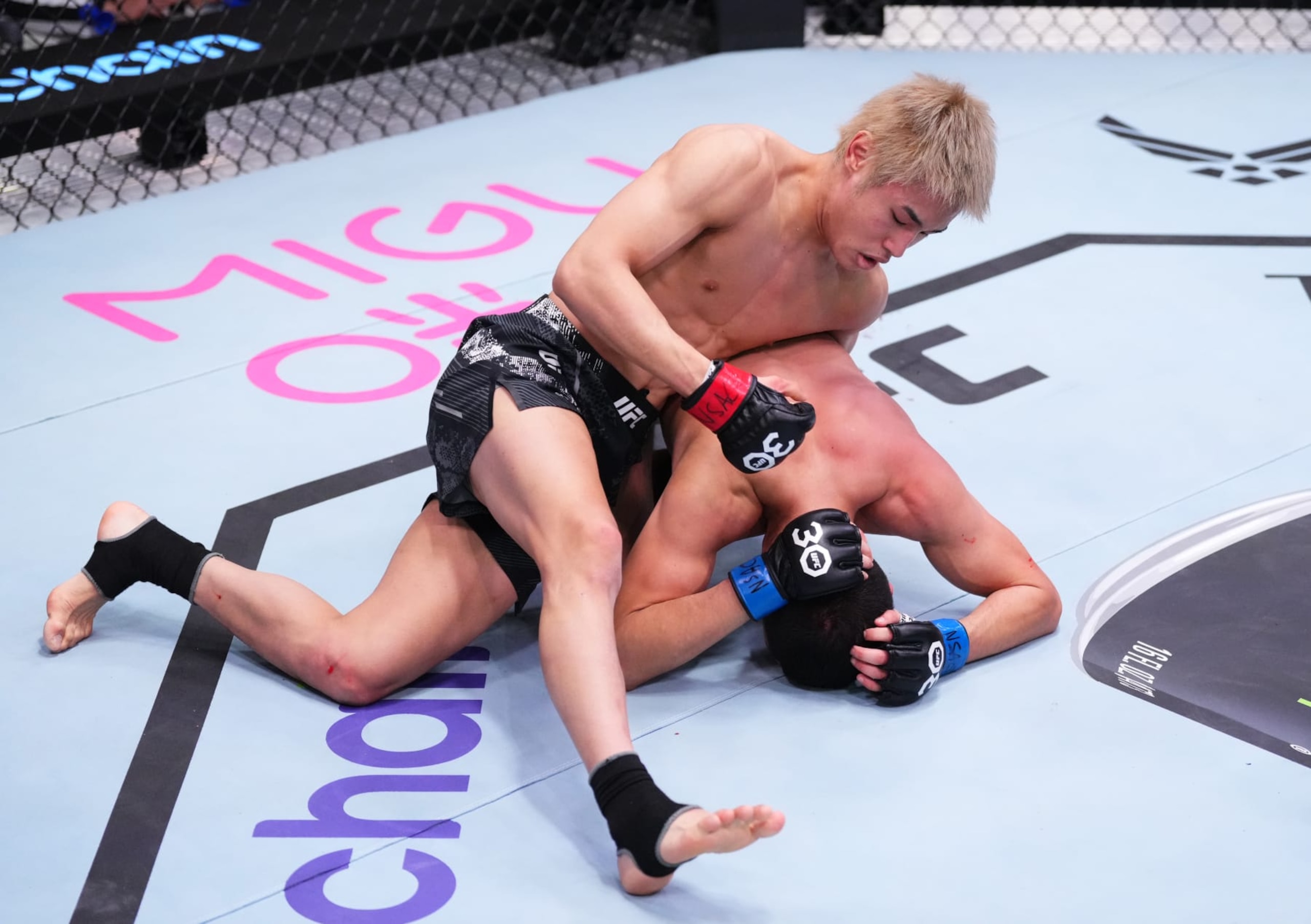 Tatsuro Taira of Japan punches Carlos Hernandez 