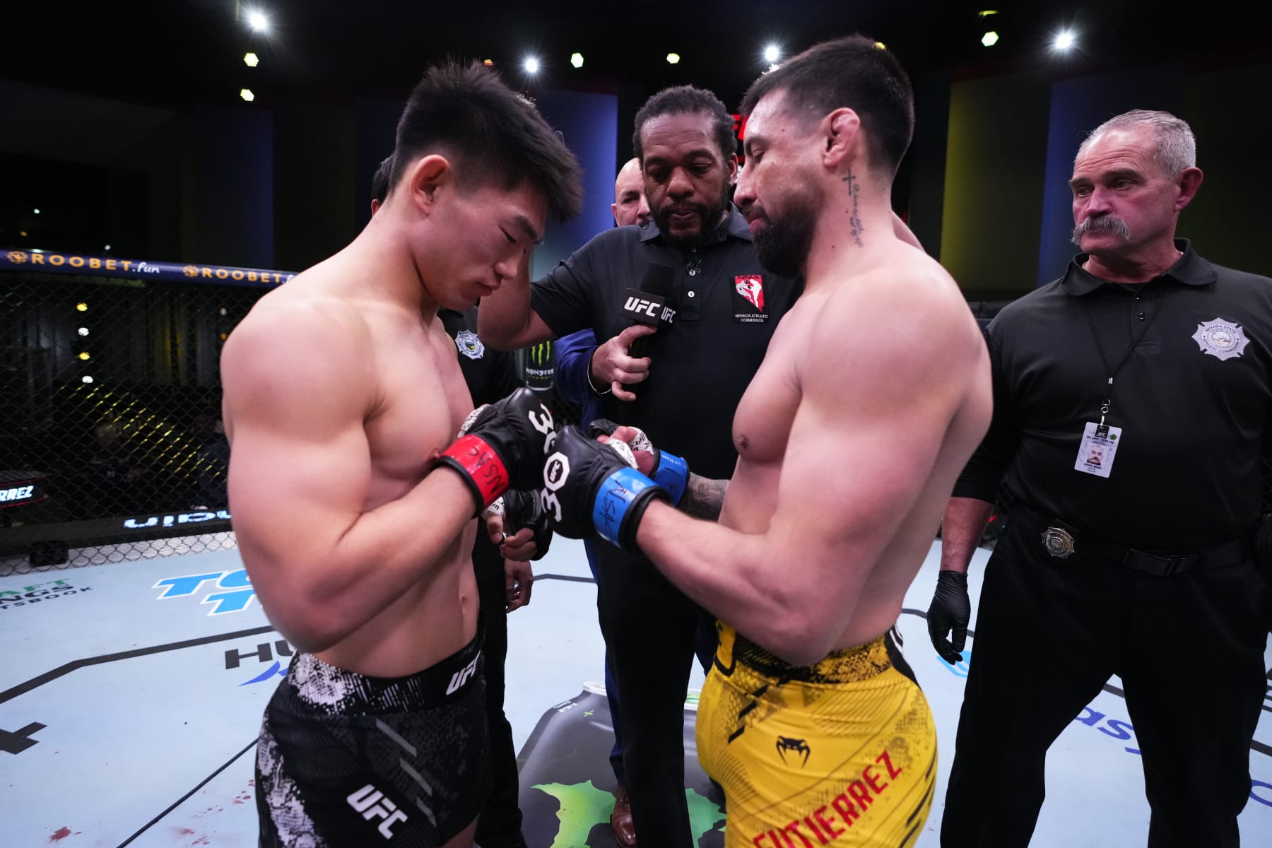 Opponents Song Yadong of China and Chris Gutierrez face off