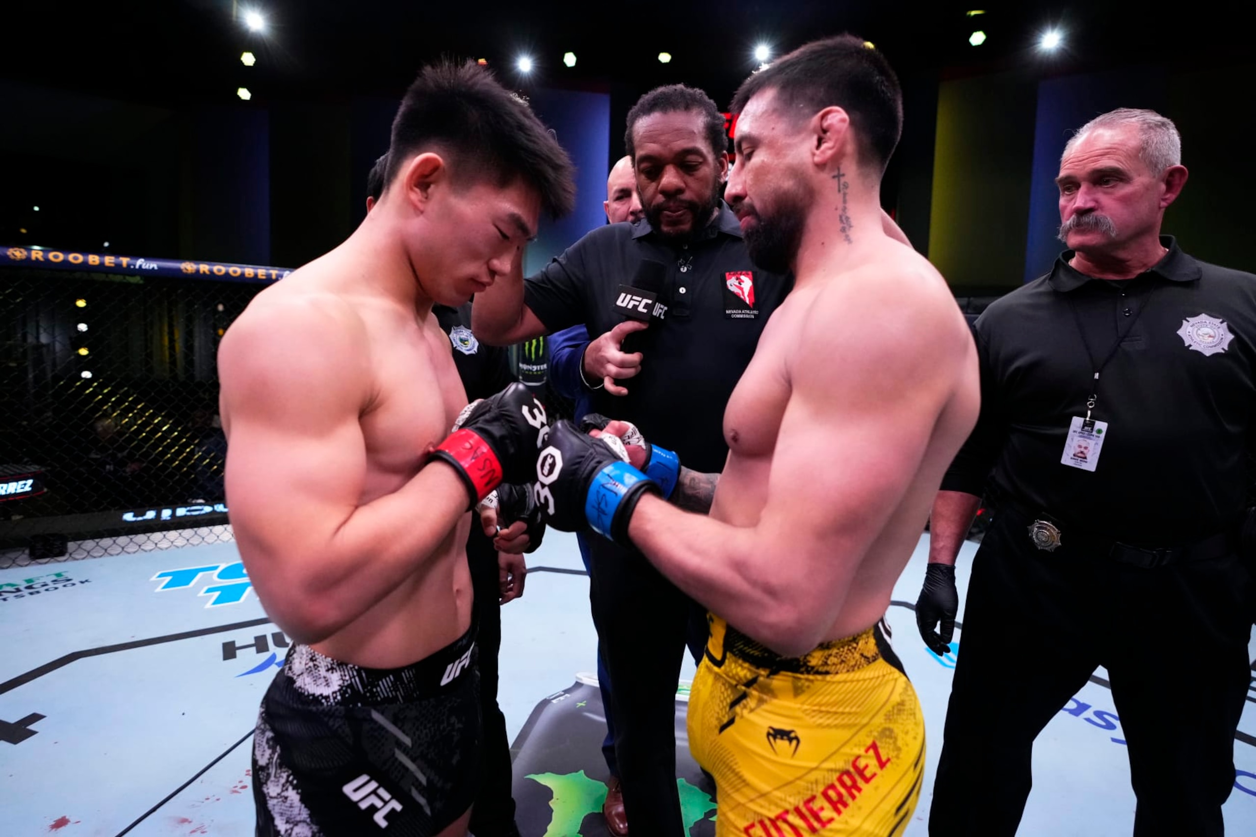Opponents Song Yadong of China and Chris Gutierrez face off