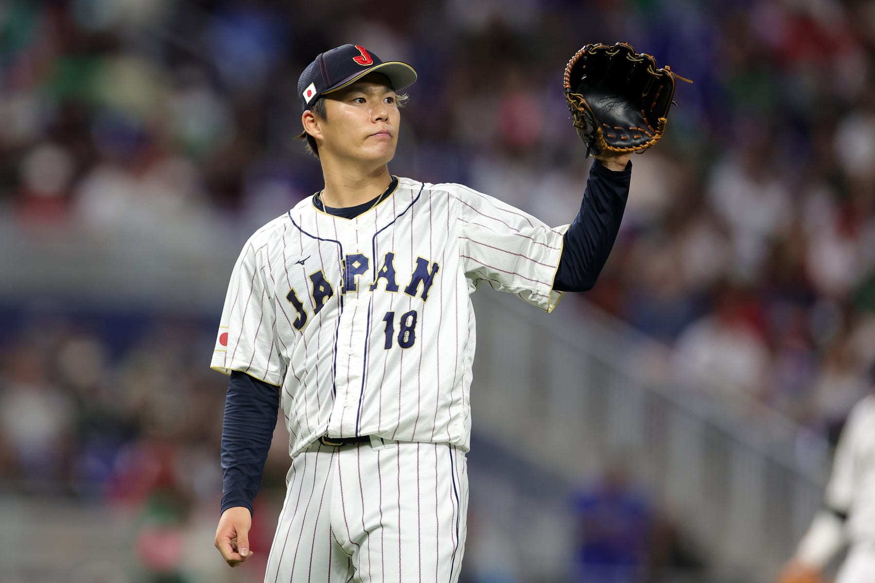 MIAMI, FLORIDA - MARCH 20: Yoshinobu Yamamoto #18 of Team Japan reacts in the fifth inning against Team Mexico during the World Baseball Classic Semifinals at loanDepot park on March 20, 2023 in Miami, Florida. (Photo by Megan Briggs/Getty Images)