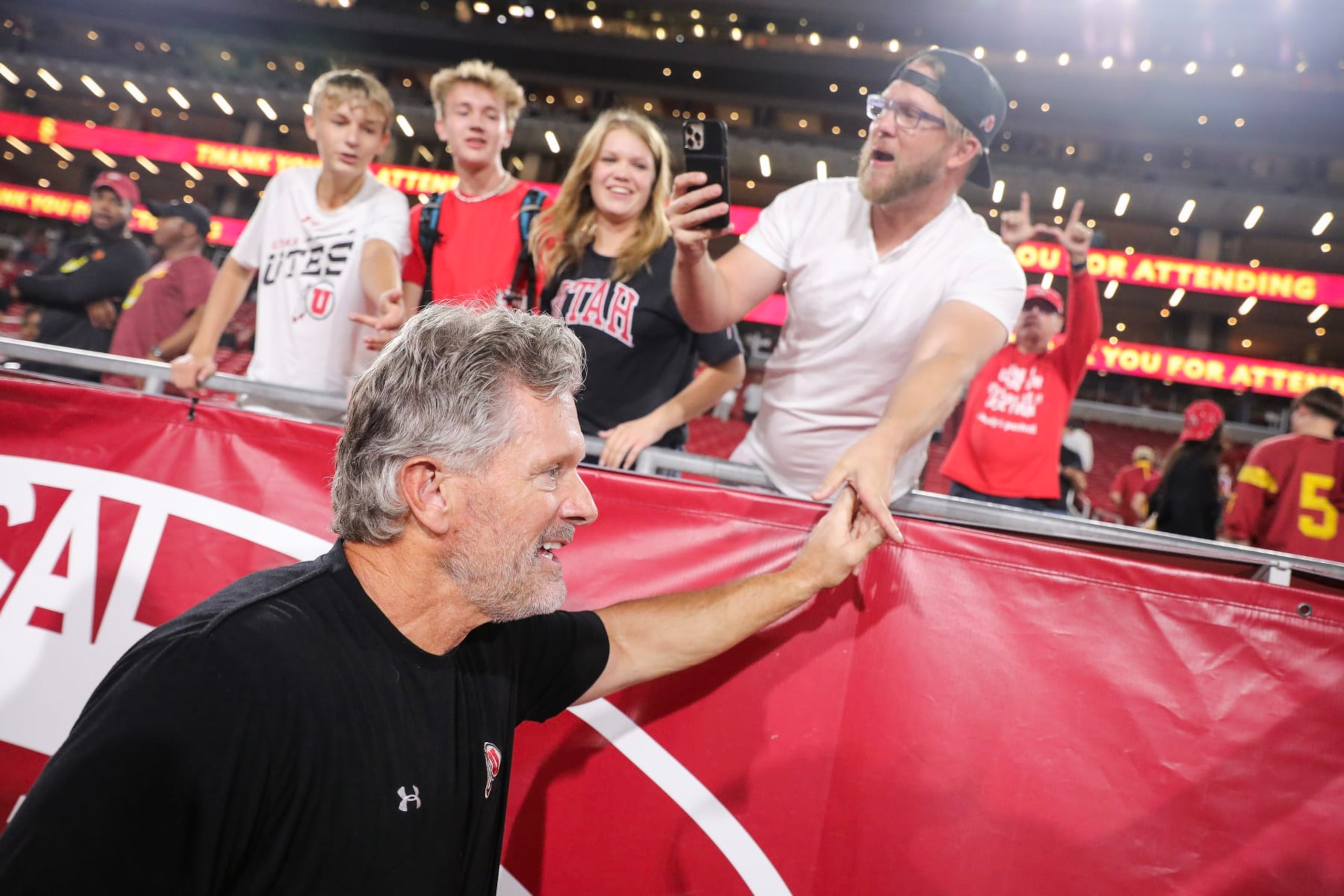 LOS ANGELES, CALIFORNIA - OCTOBER 21: Head coach Kyle Whittingham of the Utah Utes reacts with fans after defeating the USC Trojans at United Airlines Field at the Los Angeles Memorial Coliseum on October 21, 2023 in Los Angeles, California. (Photo by Meg Oliphant/Getty Images)