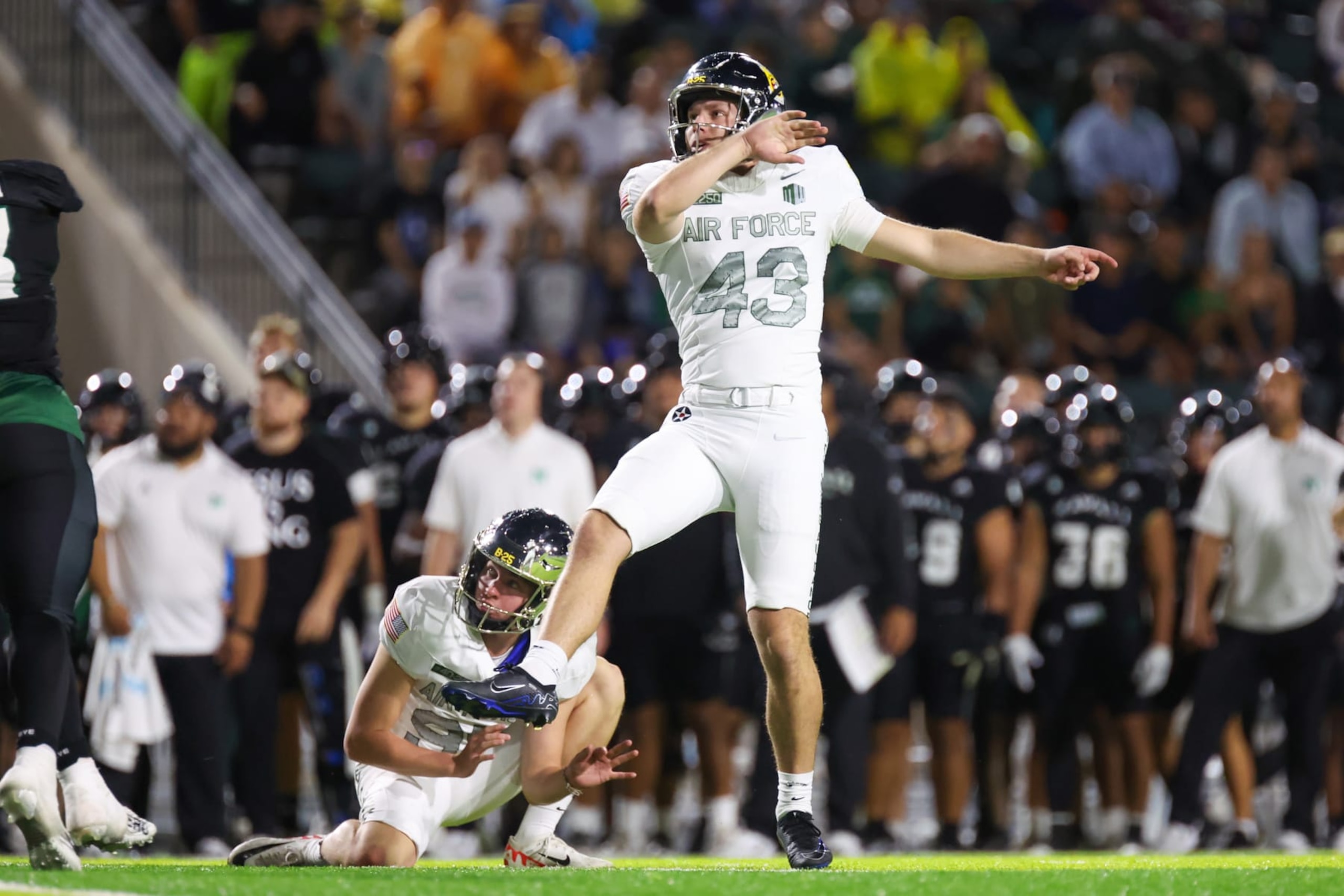 HONOLULU, HAWAII - NOVEMBER 11: Matthew Dapore #43 of the Air Force Falcons kicks a field goal as Carson Bay #95 holds the ball during the first half of the game against the Hawaii Rainbow Warriors at the Clarence T.C. Ching Athletics Complex on November 11, 2023 in Honolulu, Hawaii. (Photo by Darryl Oumi/Getty Images)