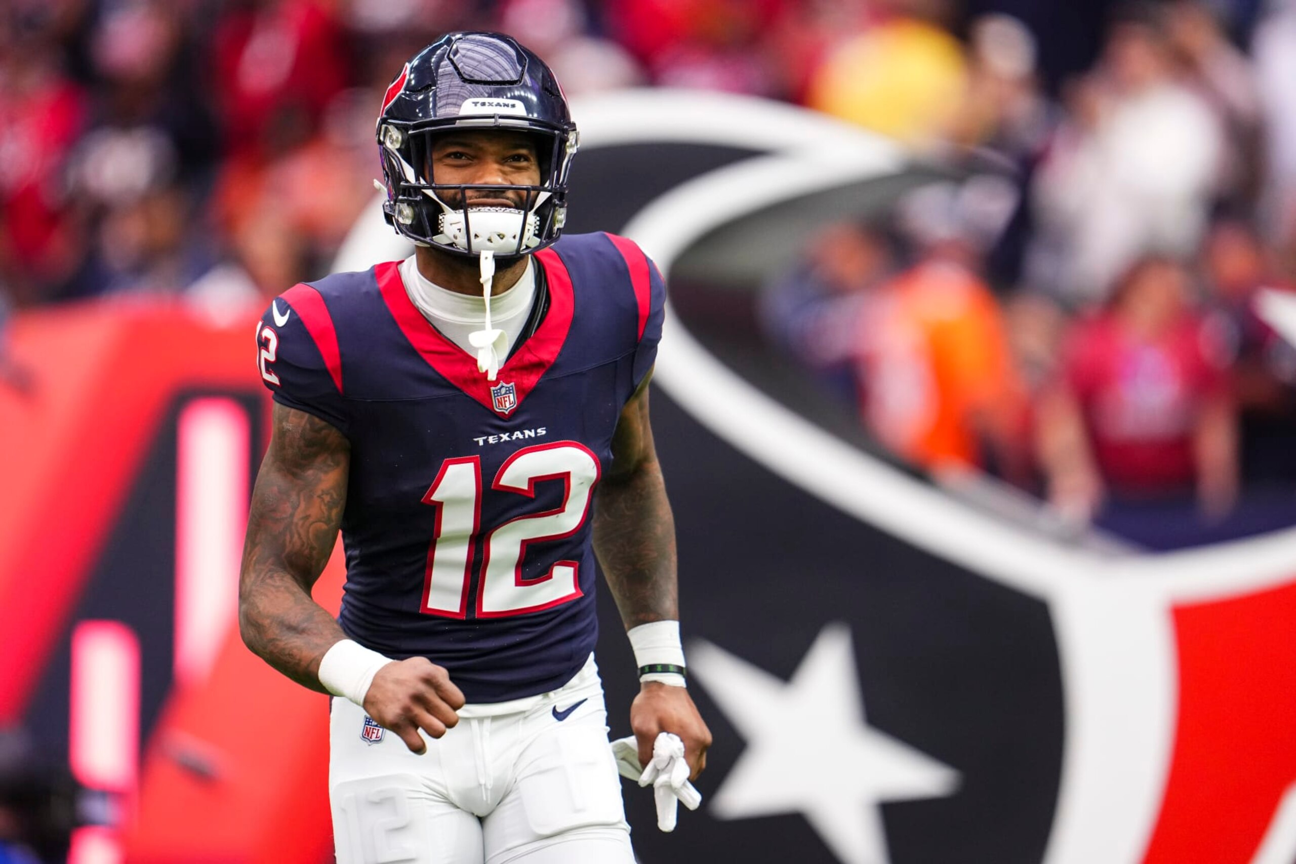 HOUSTON, TX - DECEMBER 03: Nico Collins #12 of the Houston Texans runs out of the tunnel prior to an NFL football game against the Denver Broncos at NRG Stadium on December 3, 2023 in Houston, Texas. (Photo by Cooper Neill/Getty Images)