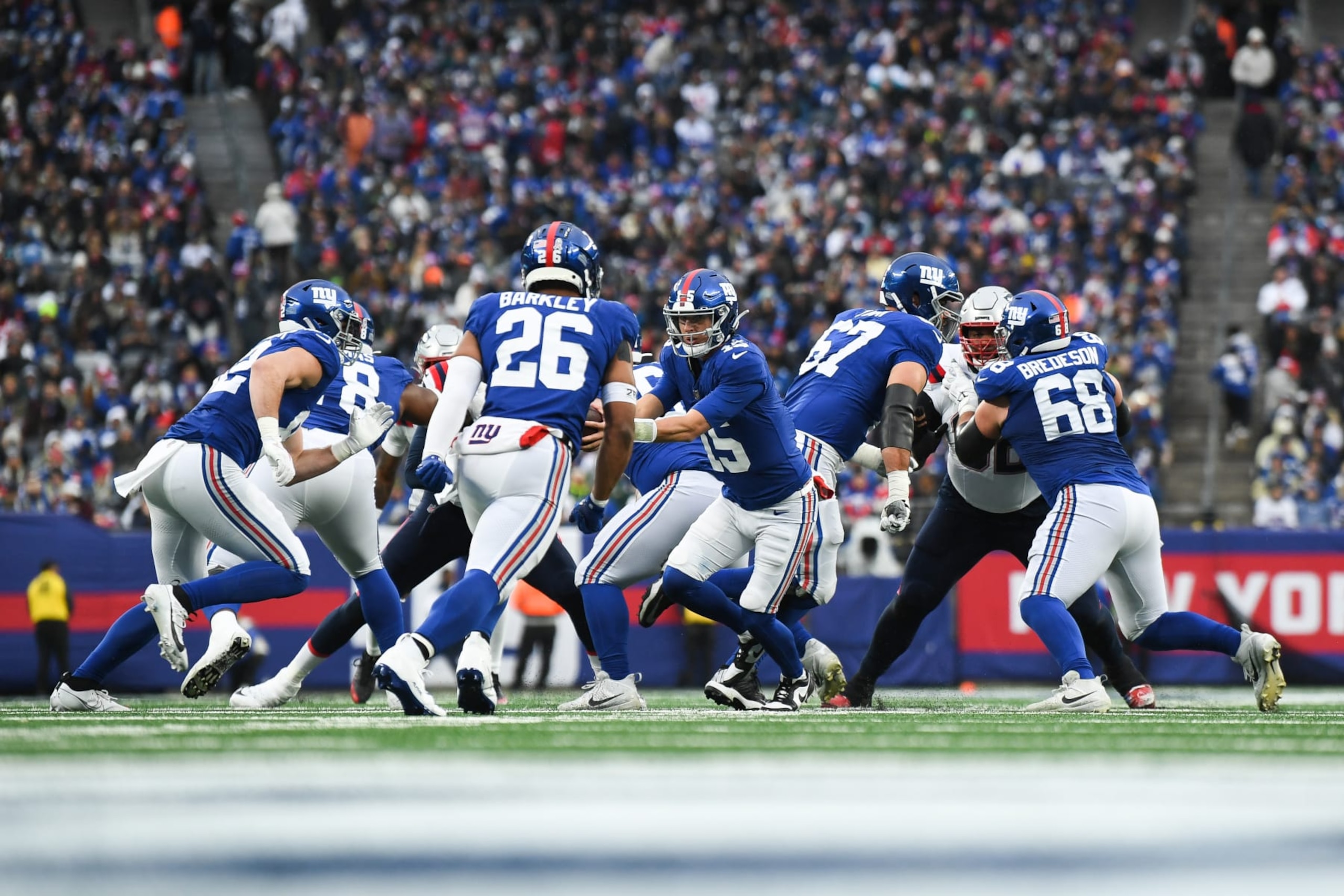 EAST RUTHERFORD, NJ - NOVEMBER 26: Tommy DeVito #15 of the New York Giants hands the ball off during the second half against the New England Patriots at MetLife Stadium on November 26, 2023 in East Rutherford, New Jersey. (Photo by Kathryn Riley/Getty Images)
